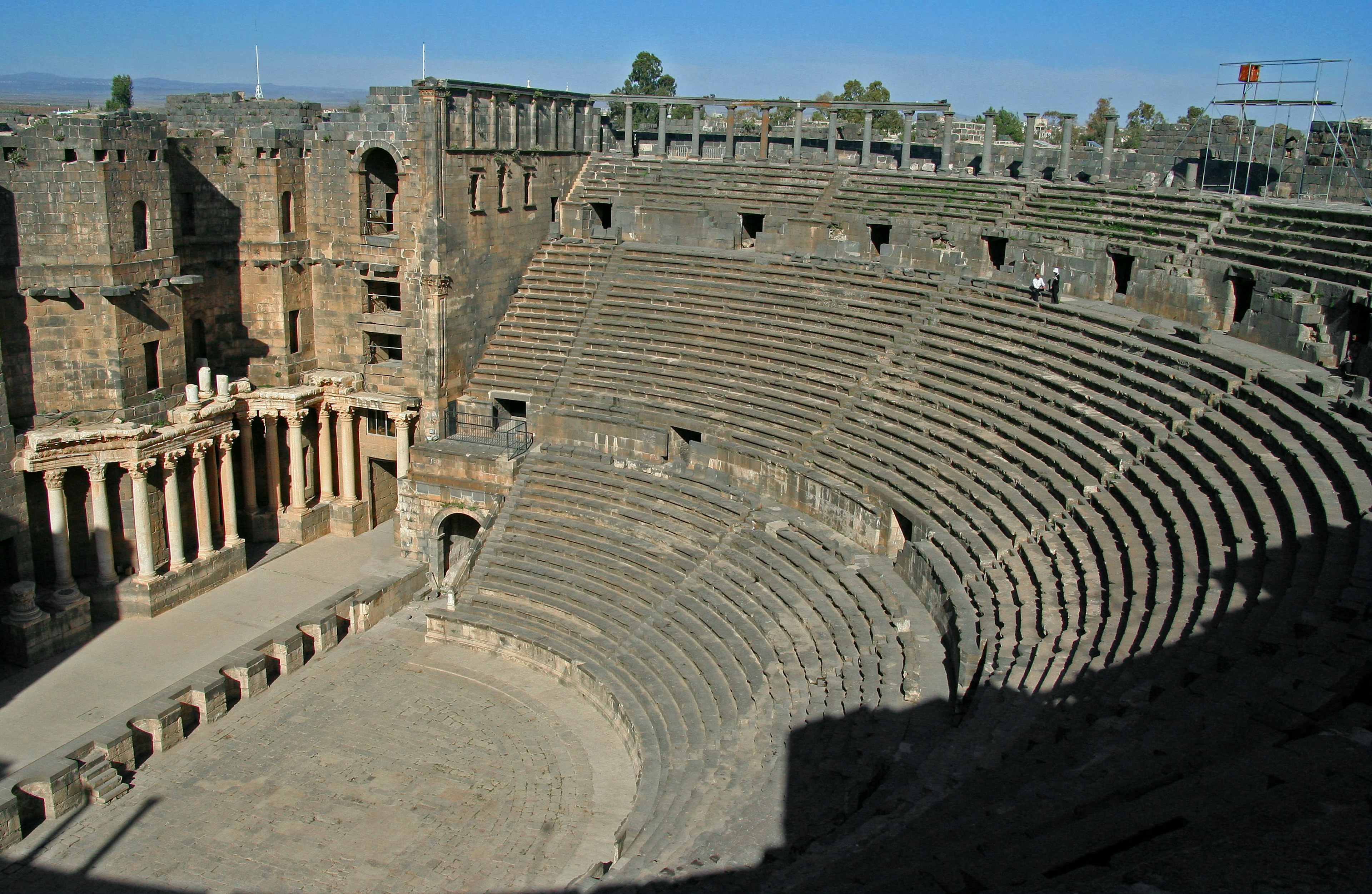 Ruins of an ancient Roman amphitheater large seating area and stone architecture