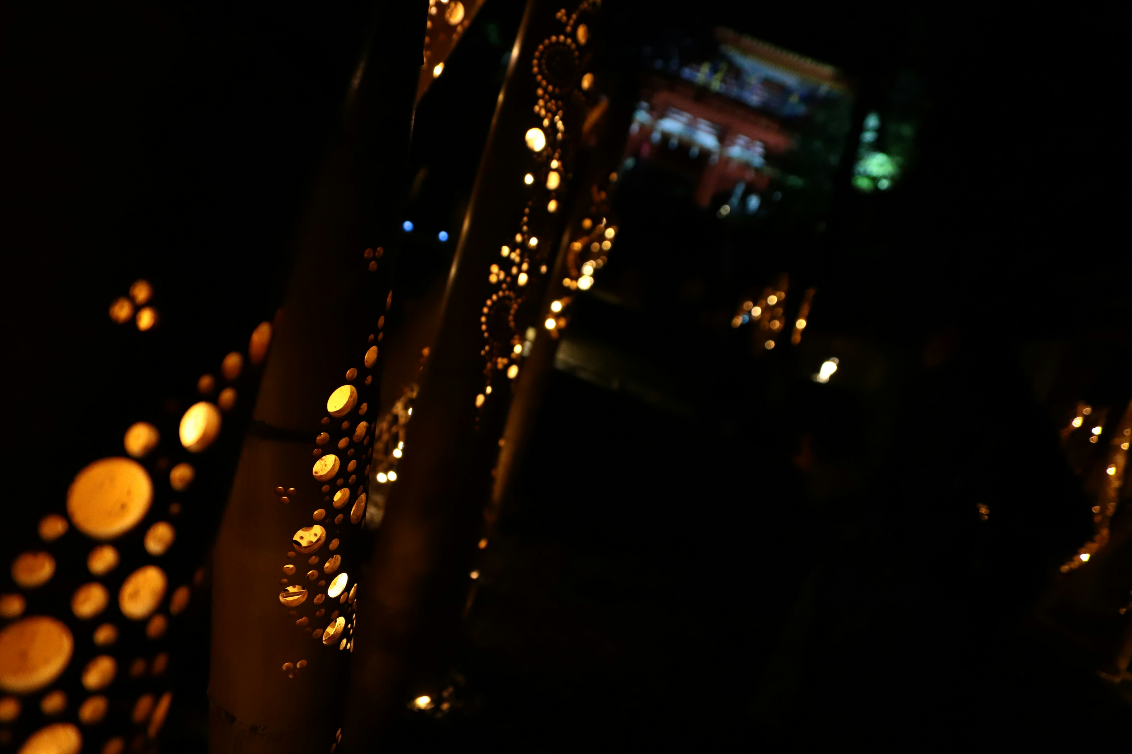 Warm glowing lights and patterned wall in a dark setting