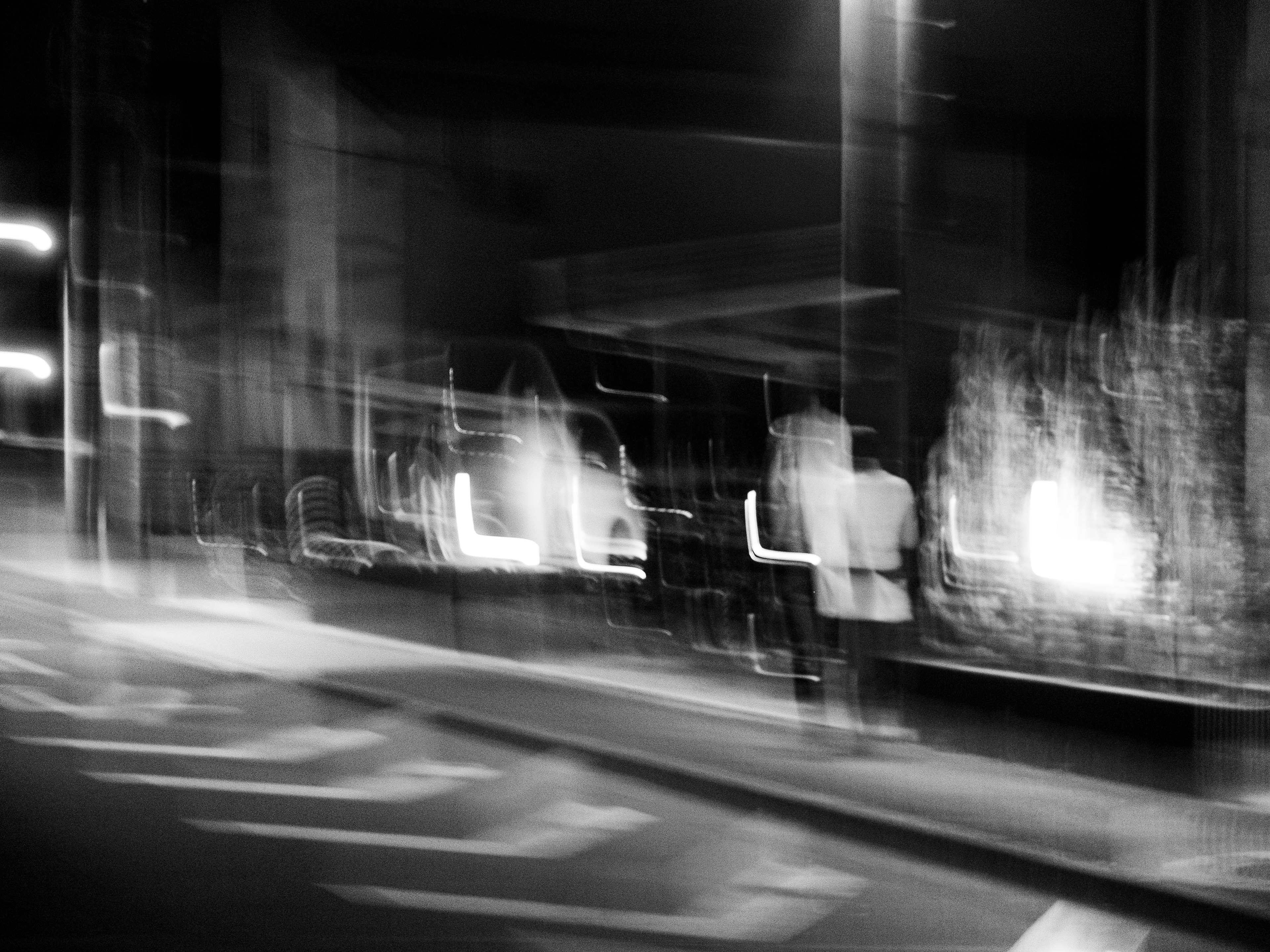 Blurred night scene of a city with figures walking