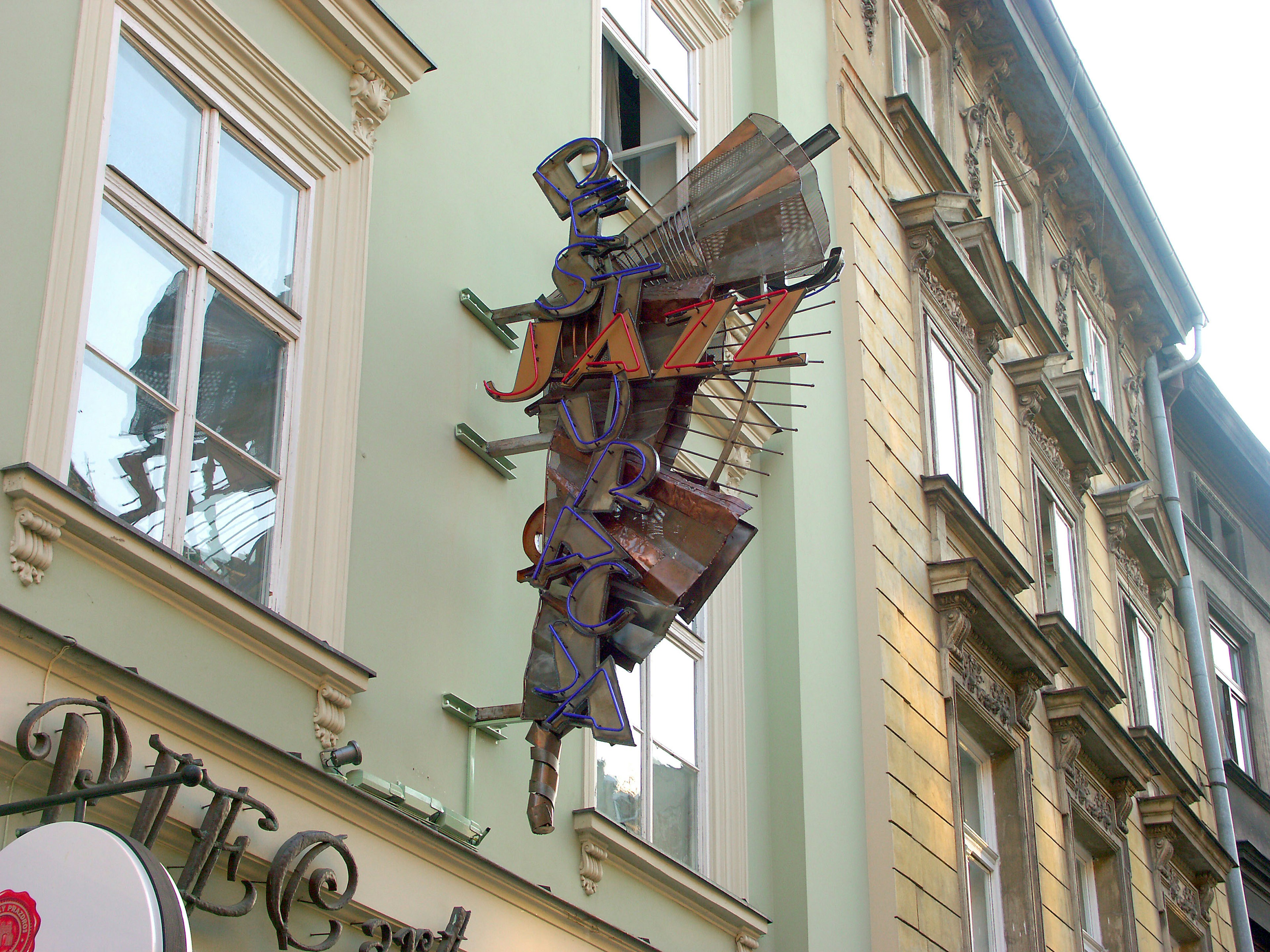 Unique sculpture of stacked chairs mounted on a building exterior