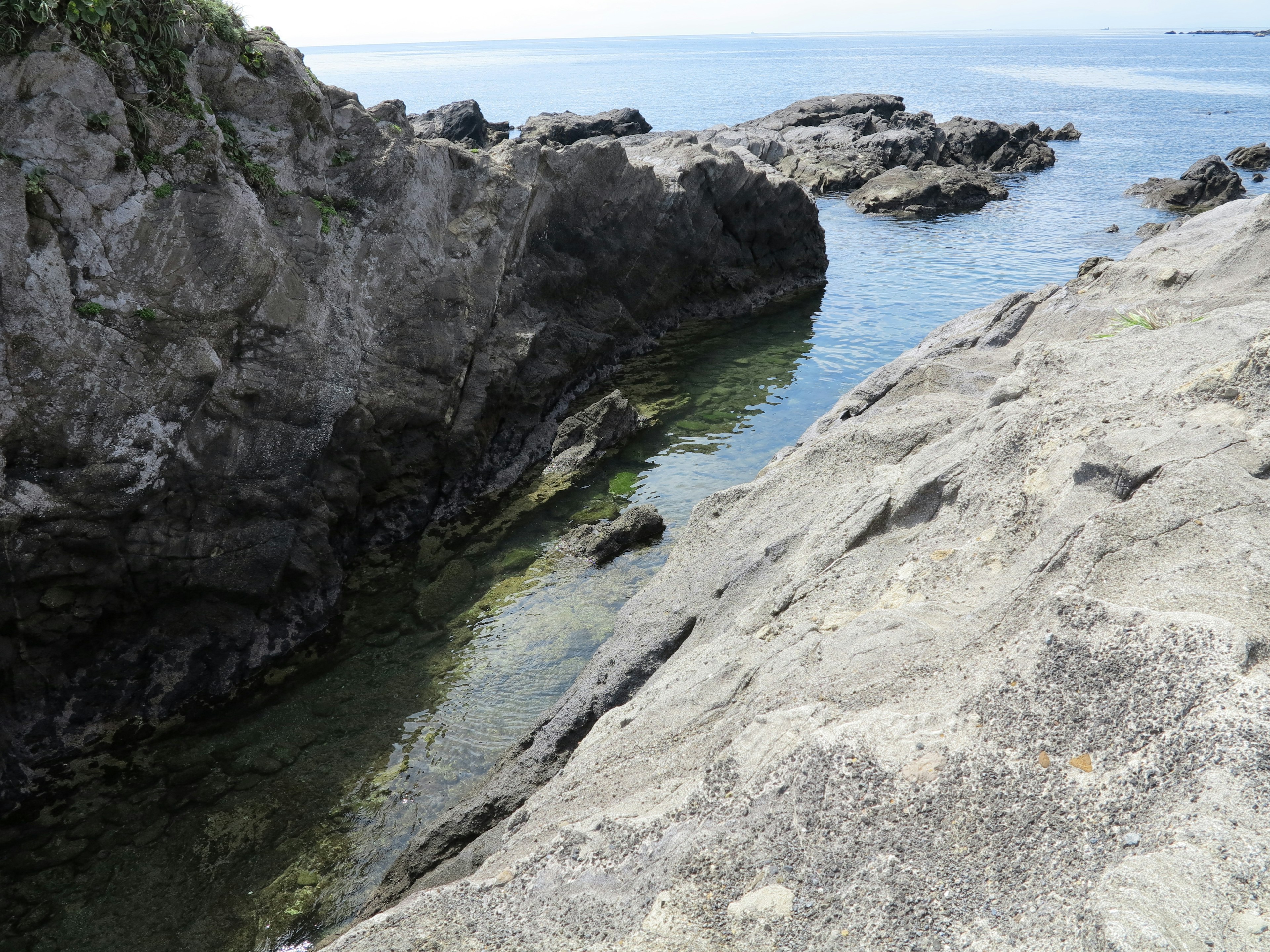 Vista del mare calmo tra formazioni rocciose