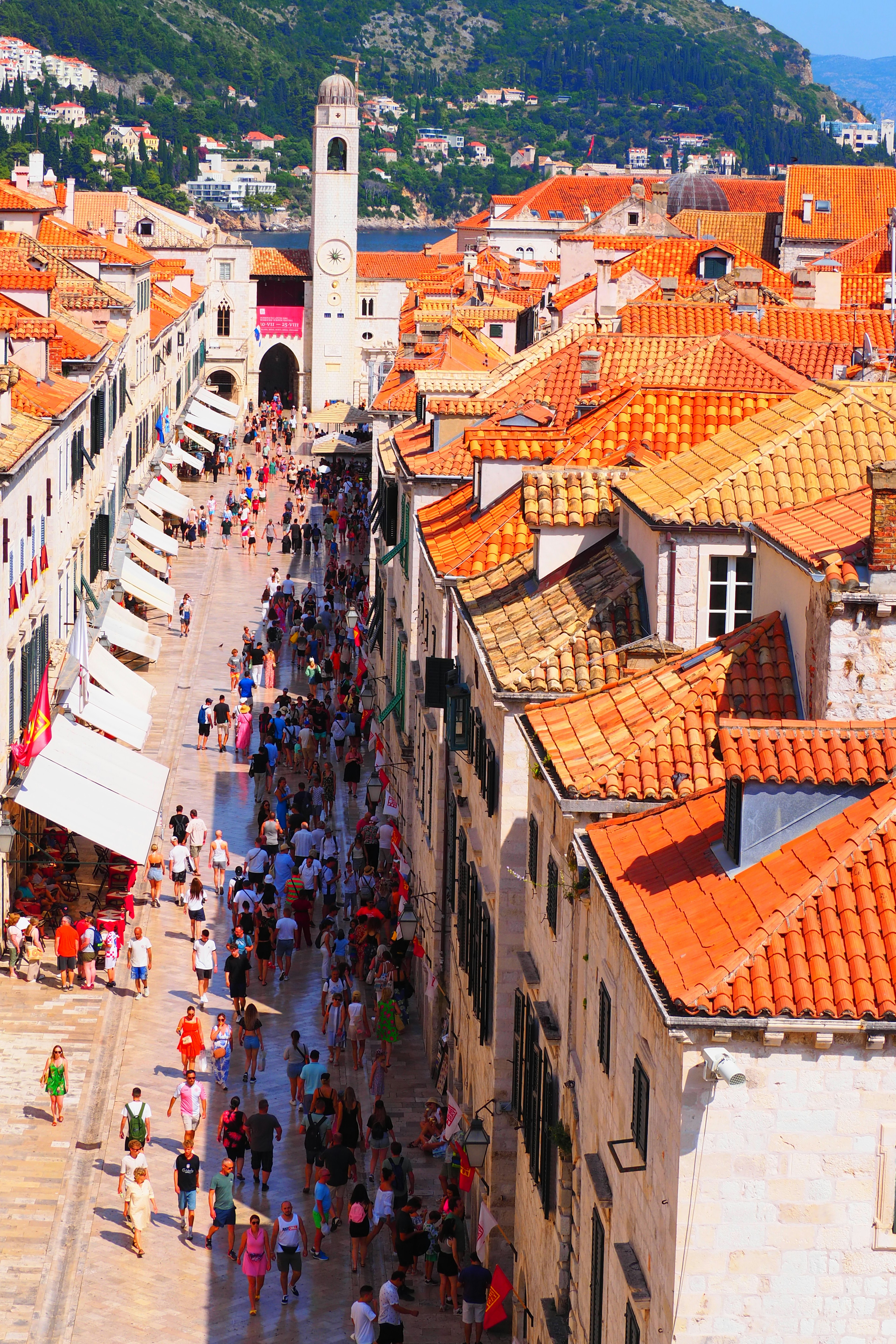 Aerial view of Dubrovnik's old town with red tiled roofs and bustling streets