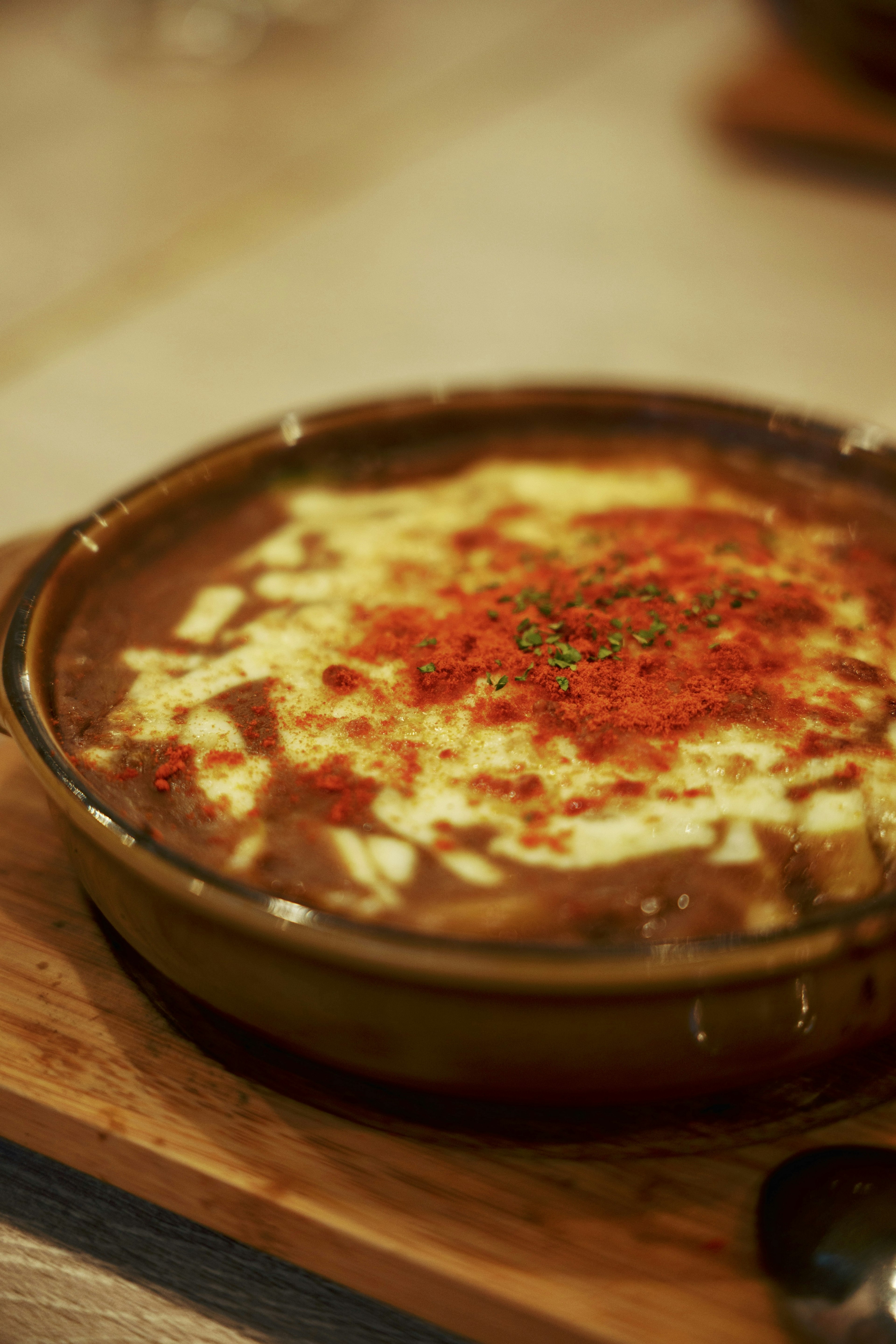 Spicy soup topped with creamy cheese