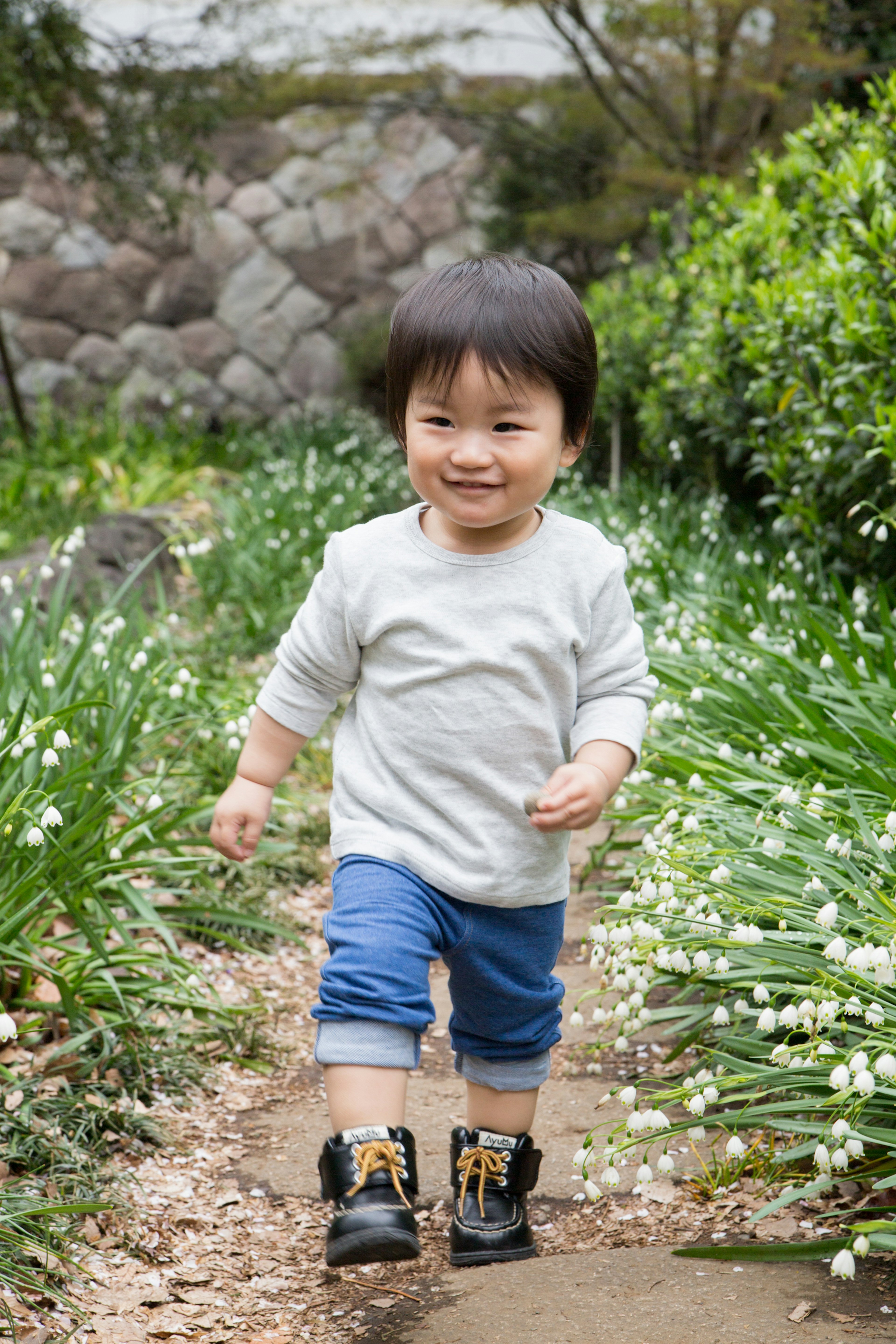 A child walking happily in a garden