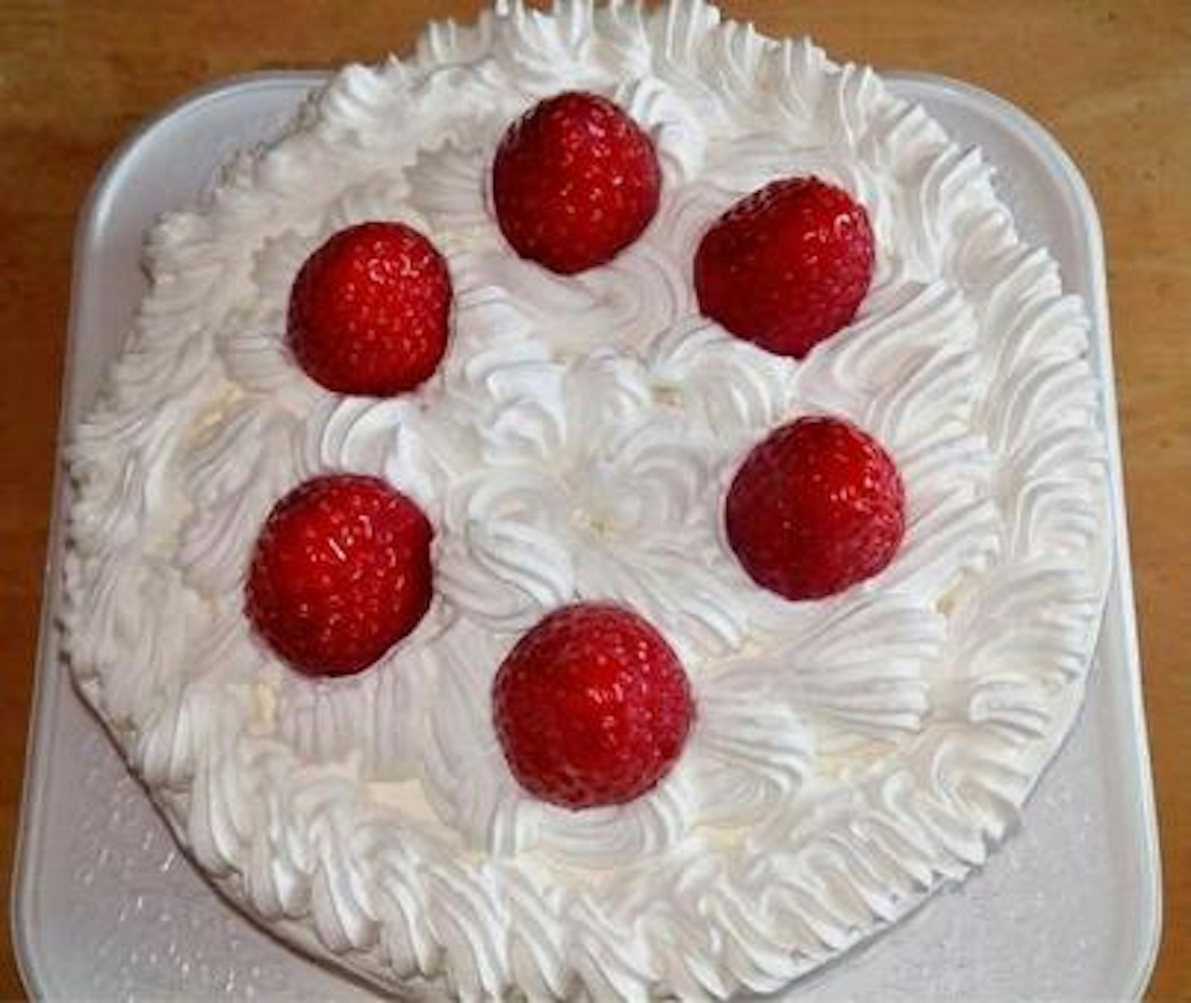 Cream cake topped with fresh raspberries