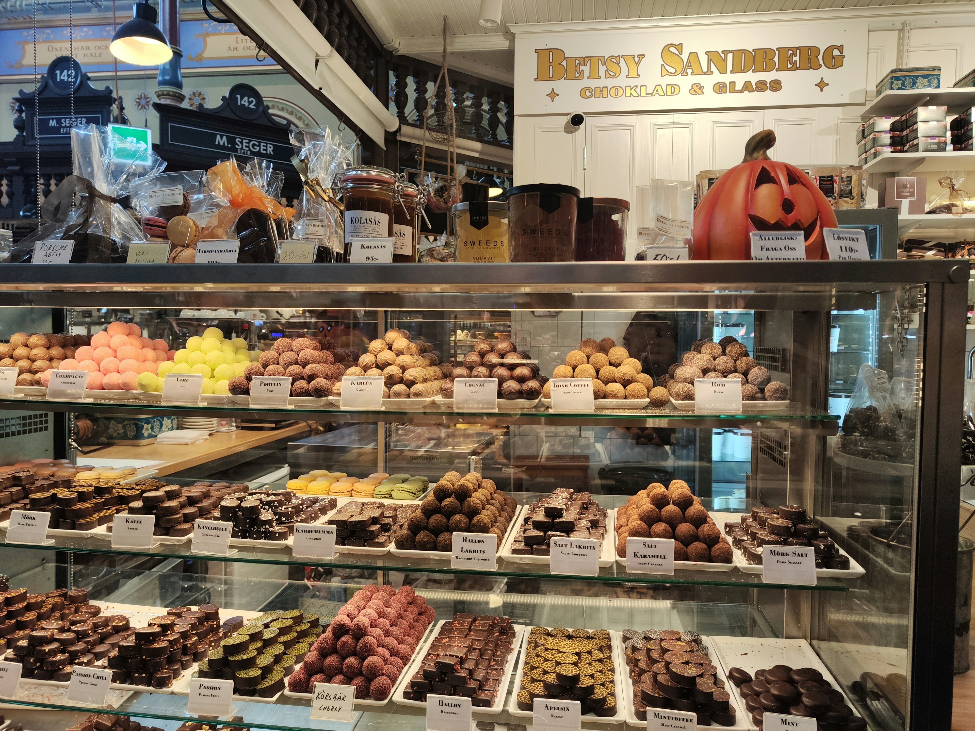 Chocolate shop display featuring colorful chocolates and a pumpkin decoration