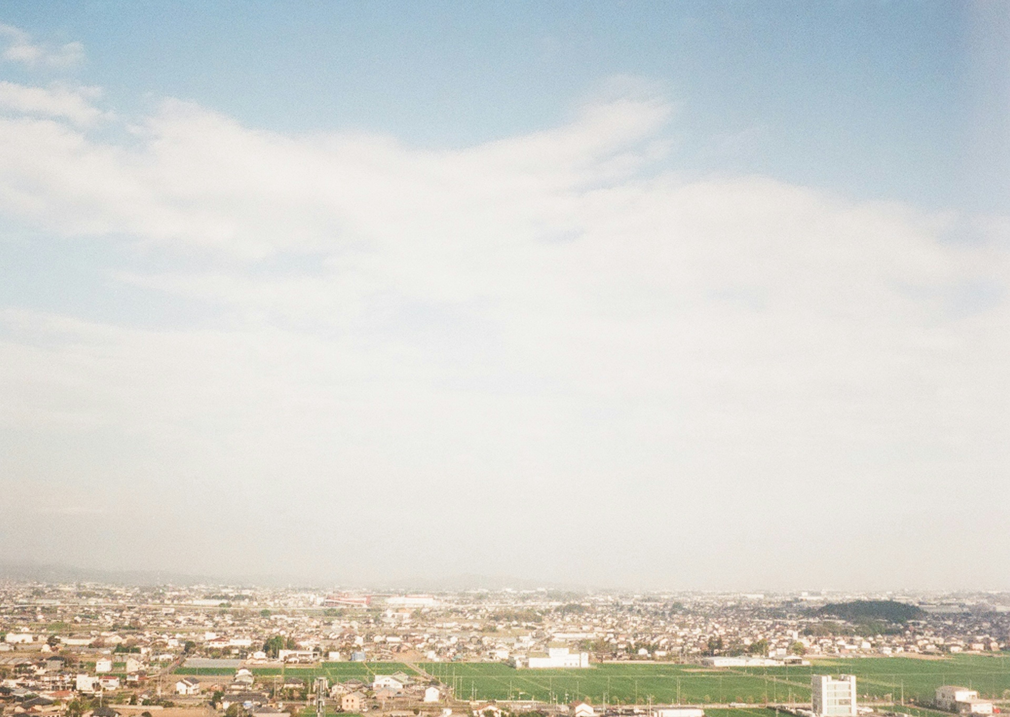 Expansive cityscape under a blue sky