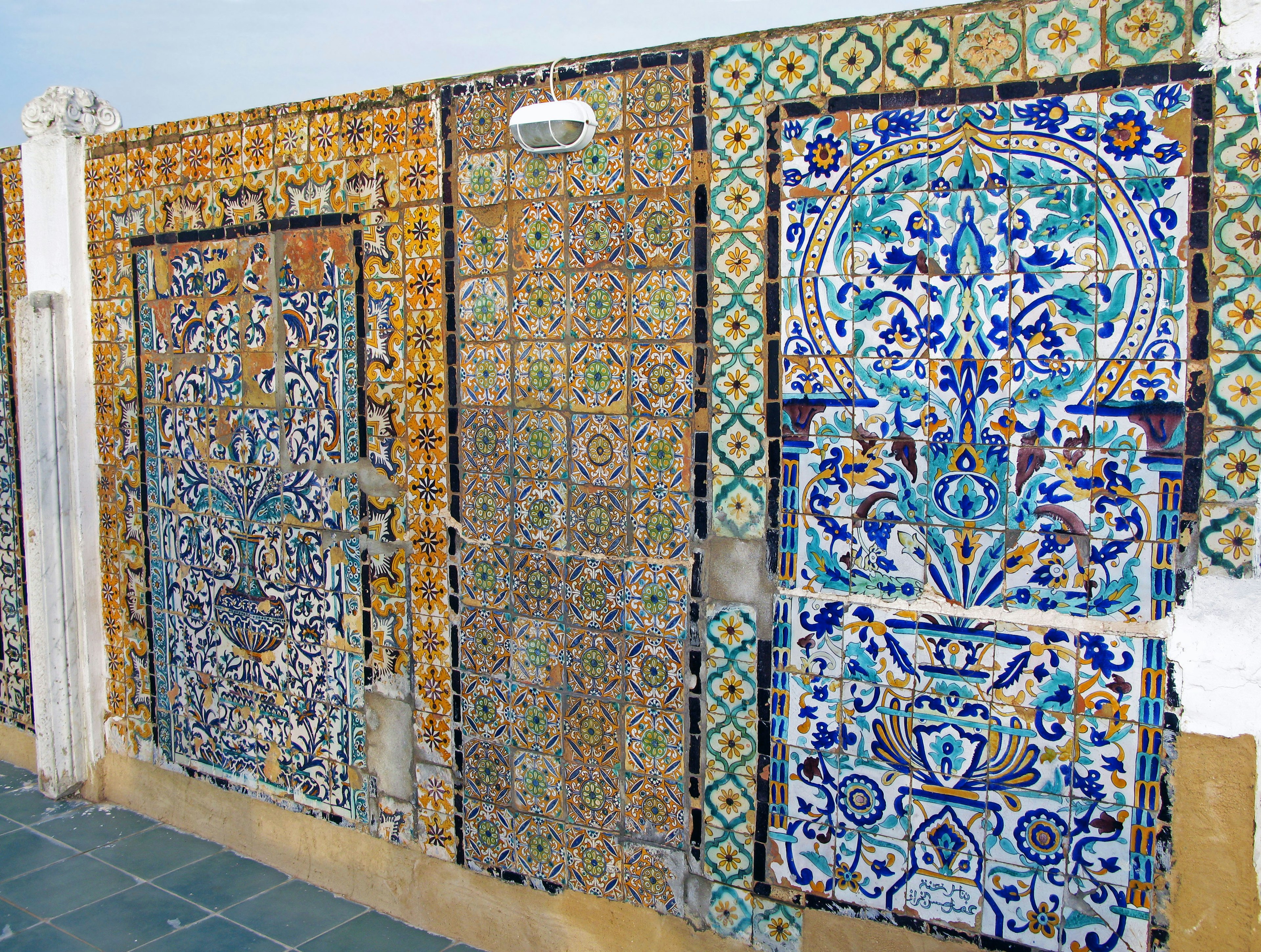 Partial view of a wall decorated with colorful tiles