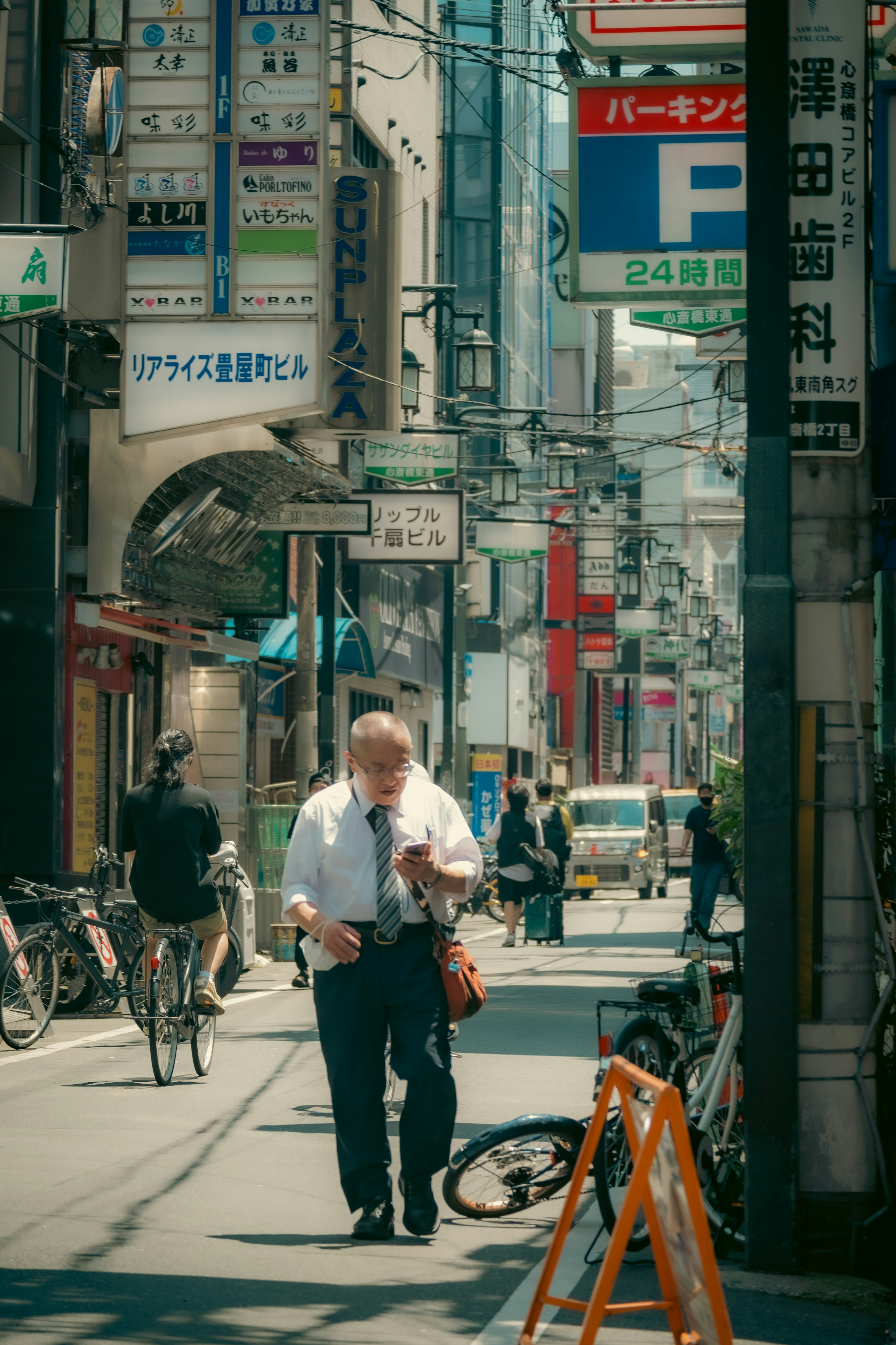 Businessman walking in a city street with bicycles