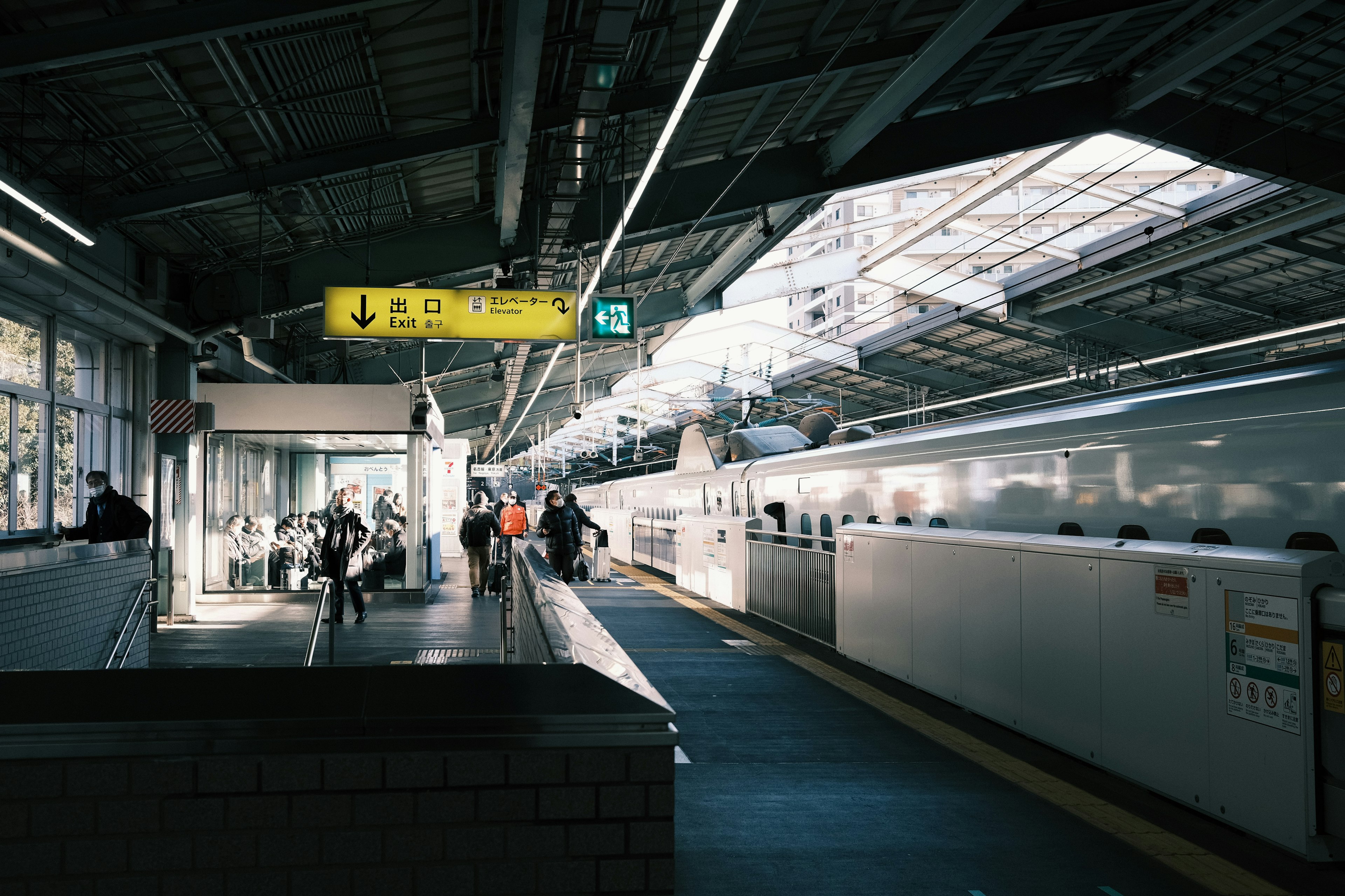 Stasiun cerah dengan Shinkansen dan penumpang