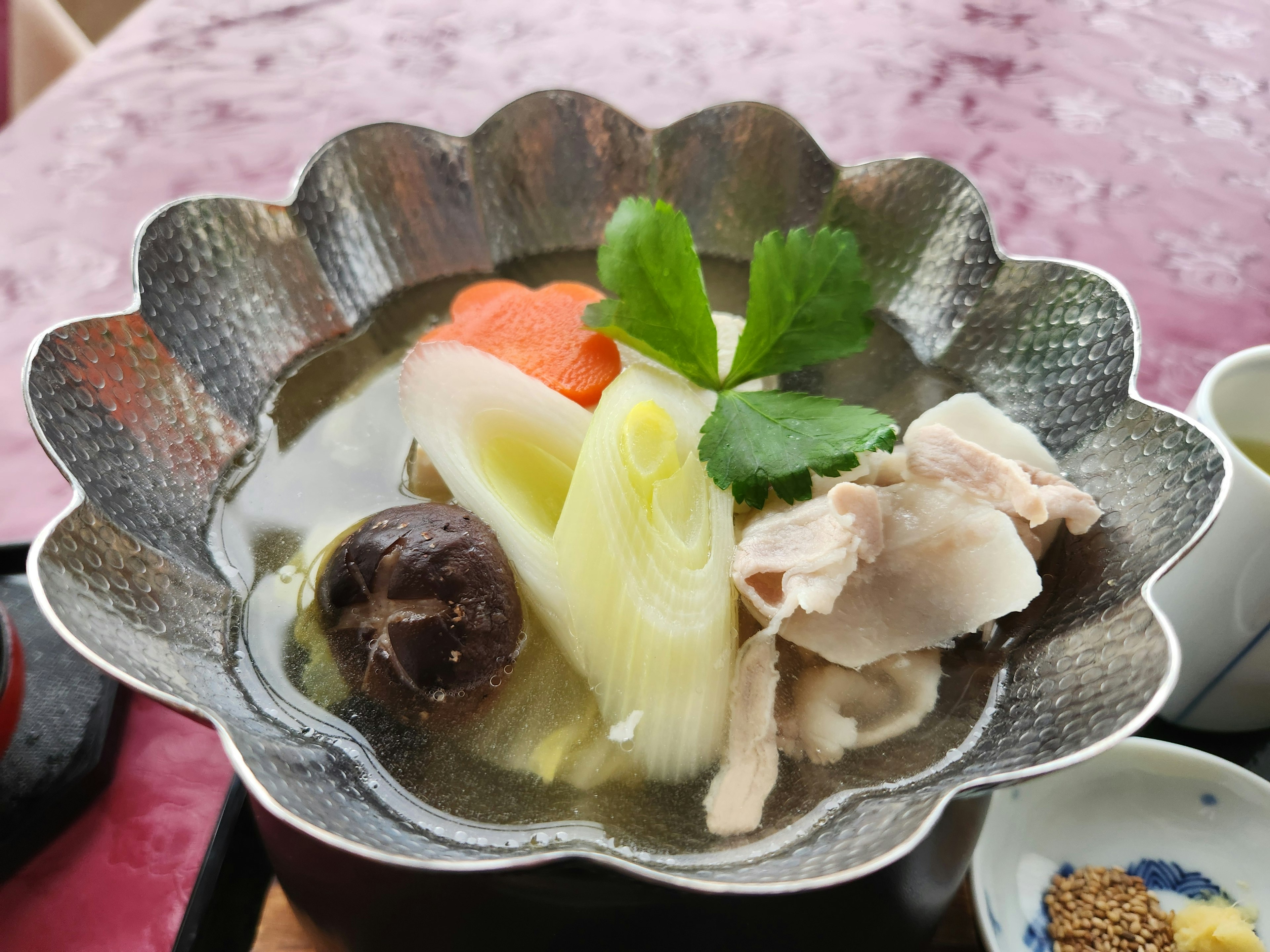 Image of a soup dish with colorful vegetables and chicken