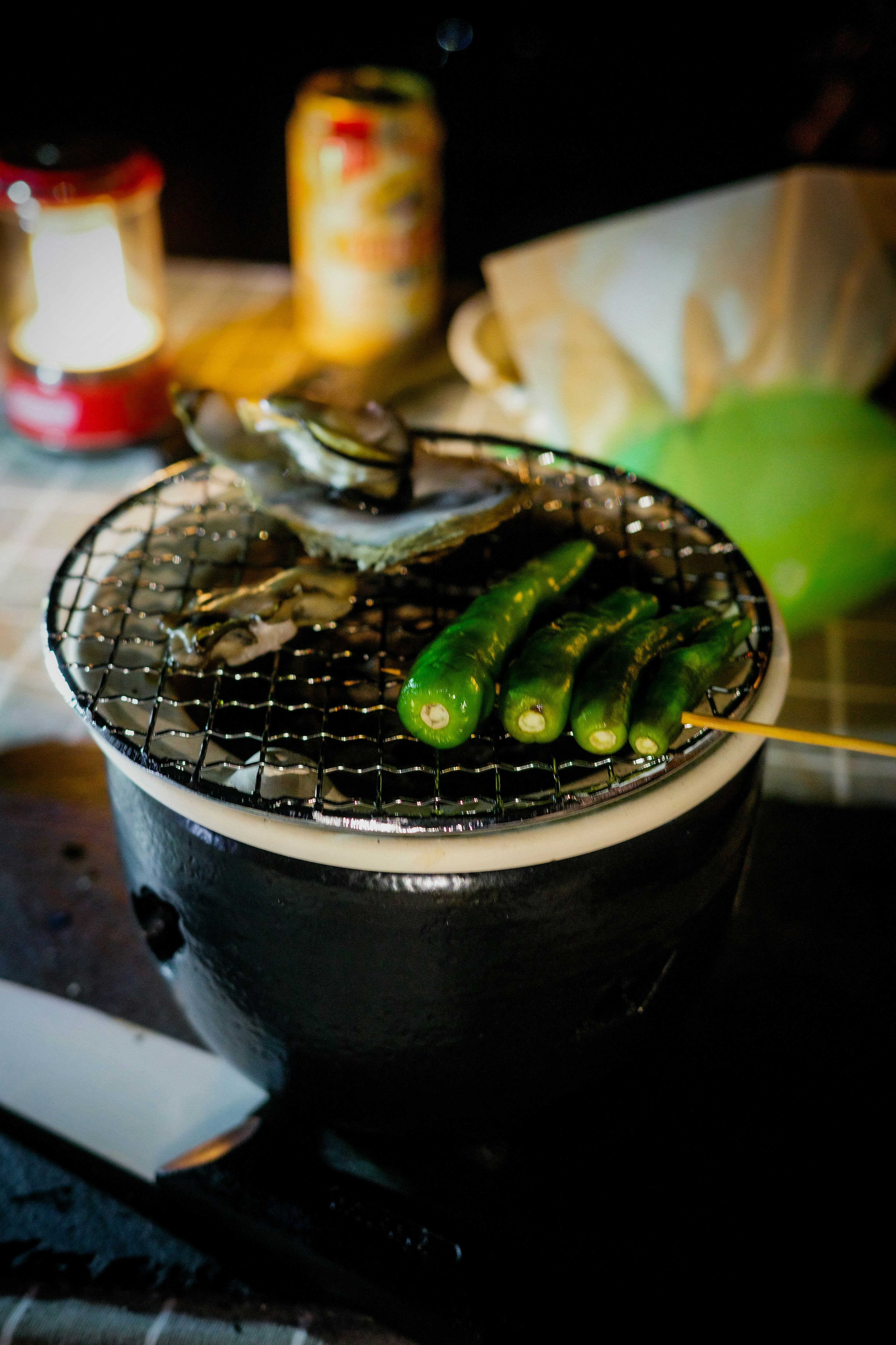 Grilled fish and green chili skewers on a charcoal grill