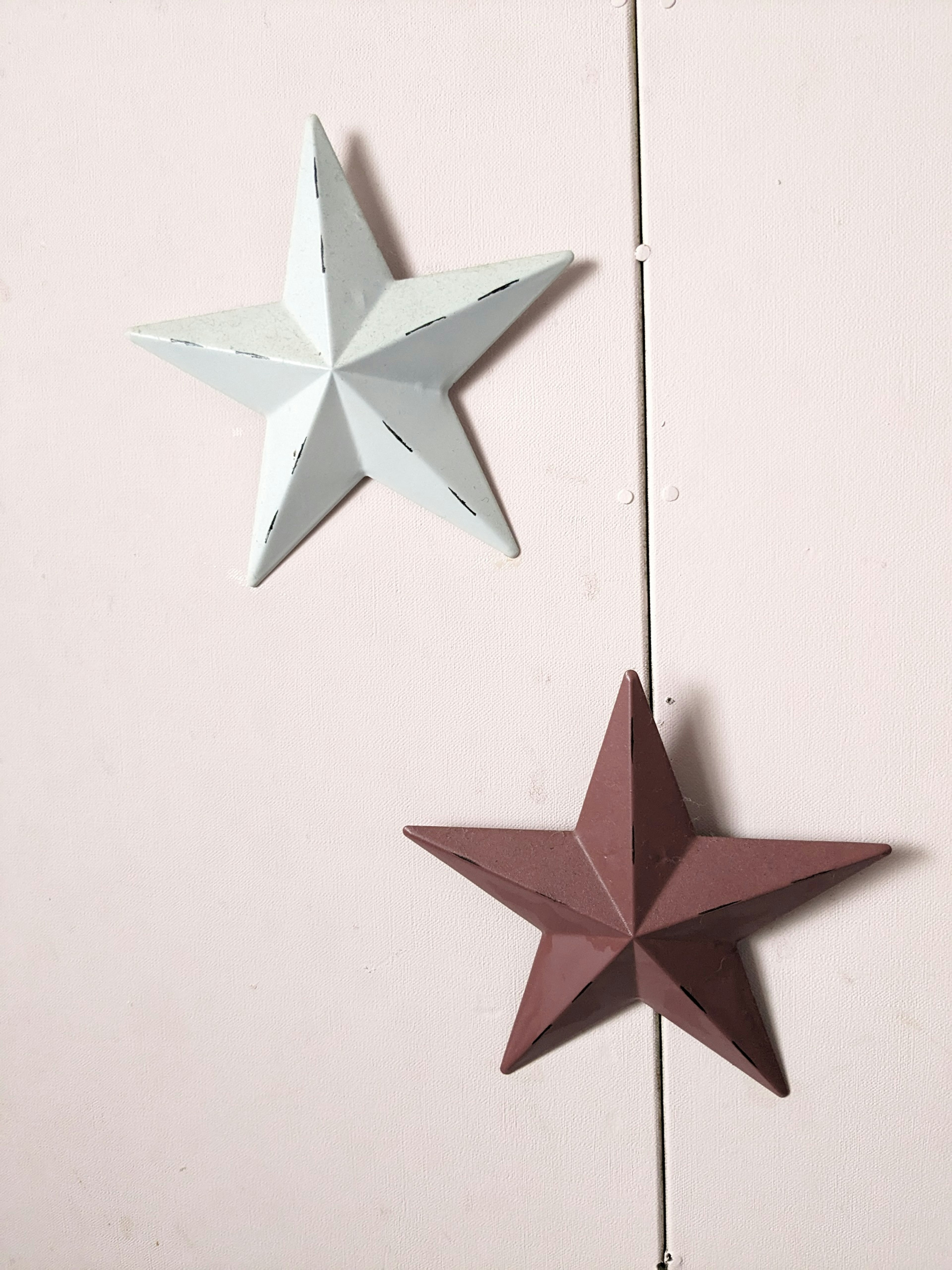 Three-dimensional star decorations in blue and brown hanging on a wall