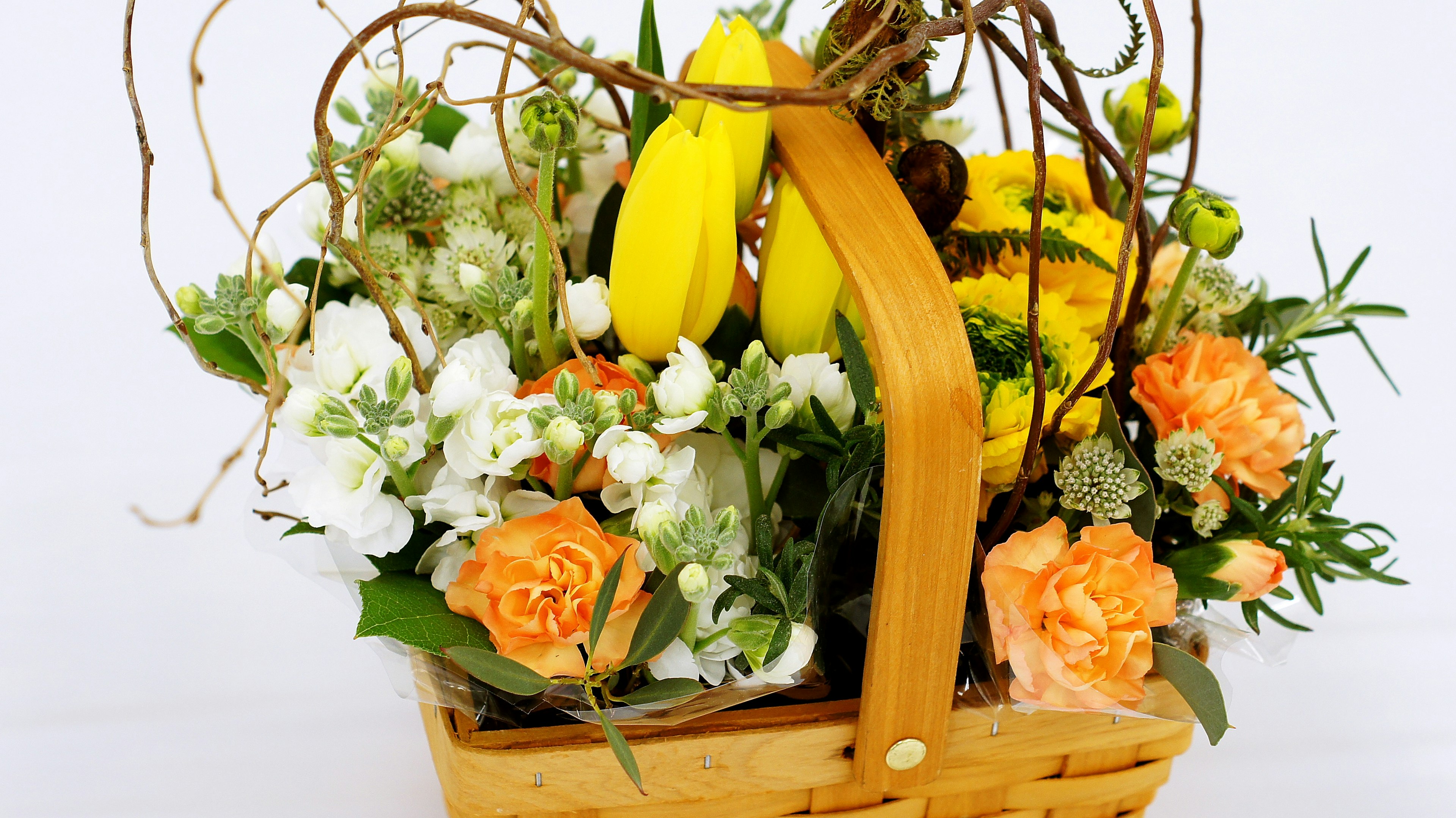 Arreglo floral colorido con frutas en una canasta