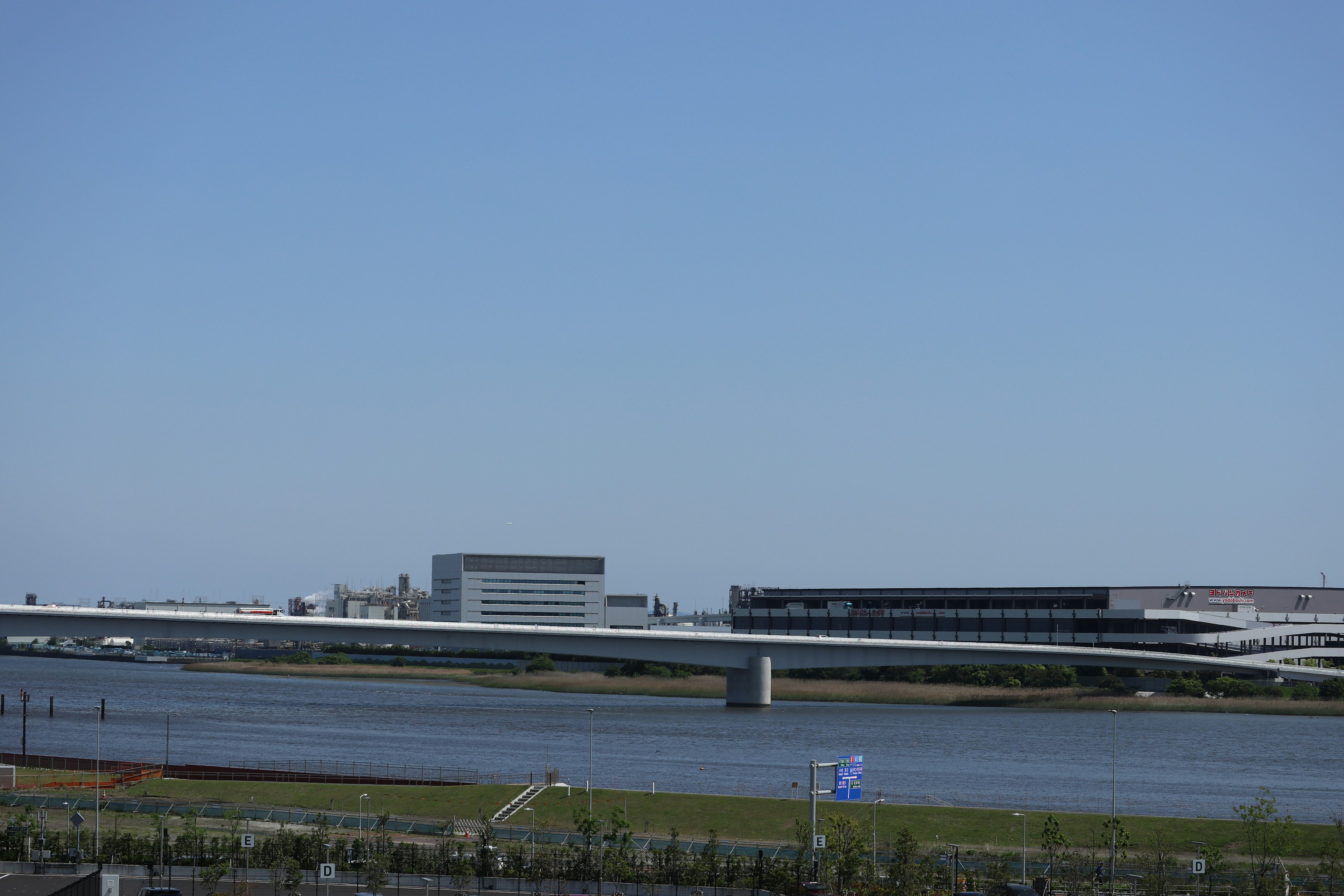 River under a clear blue sky with modern buildings