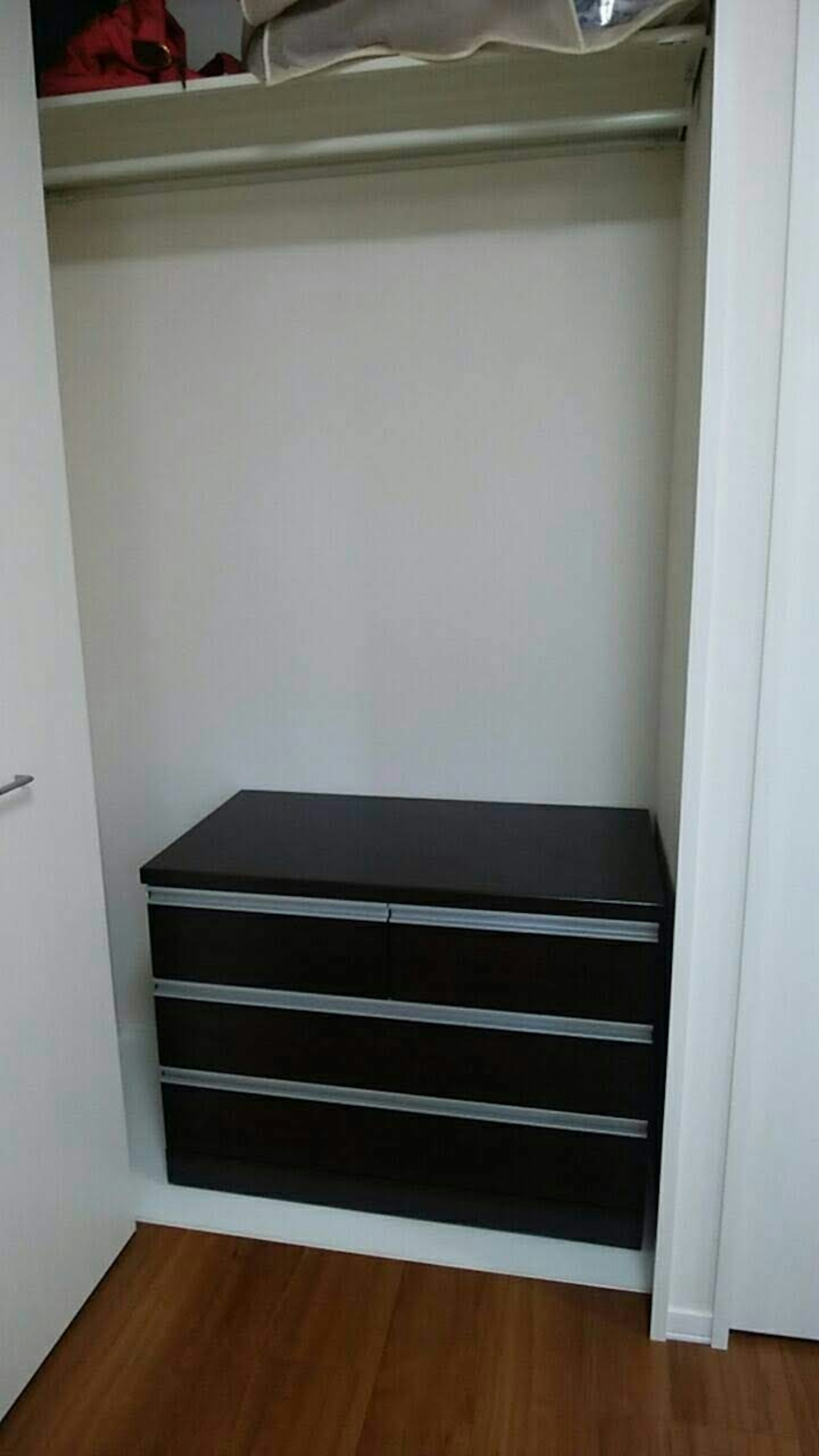 A black drawer storage box inside a closet