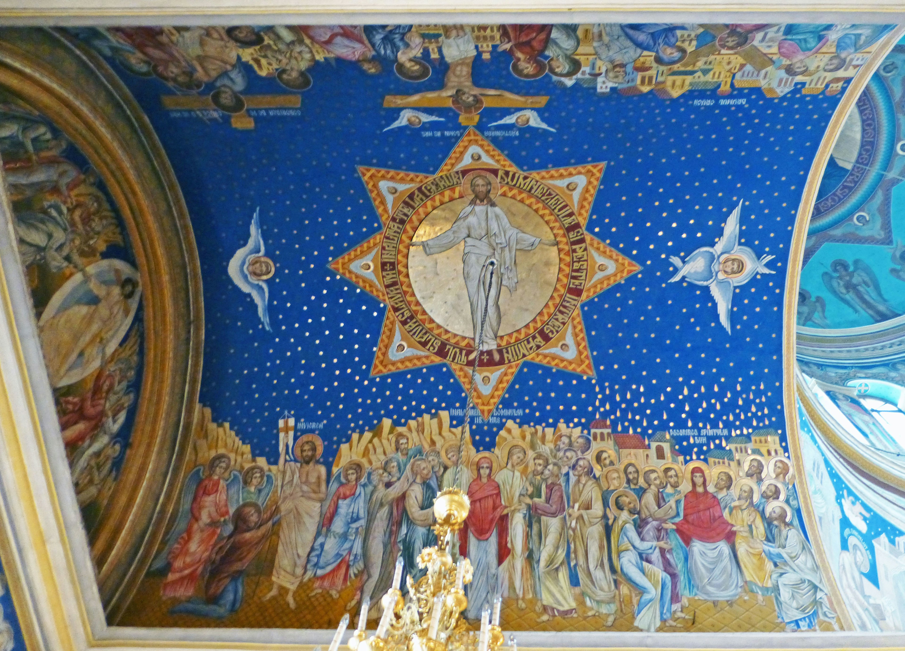 A magnificent fresco of Christ surrounded by people on a blue ceiling