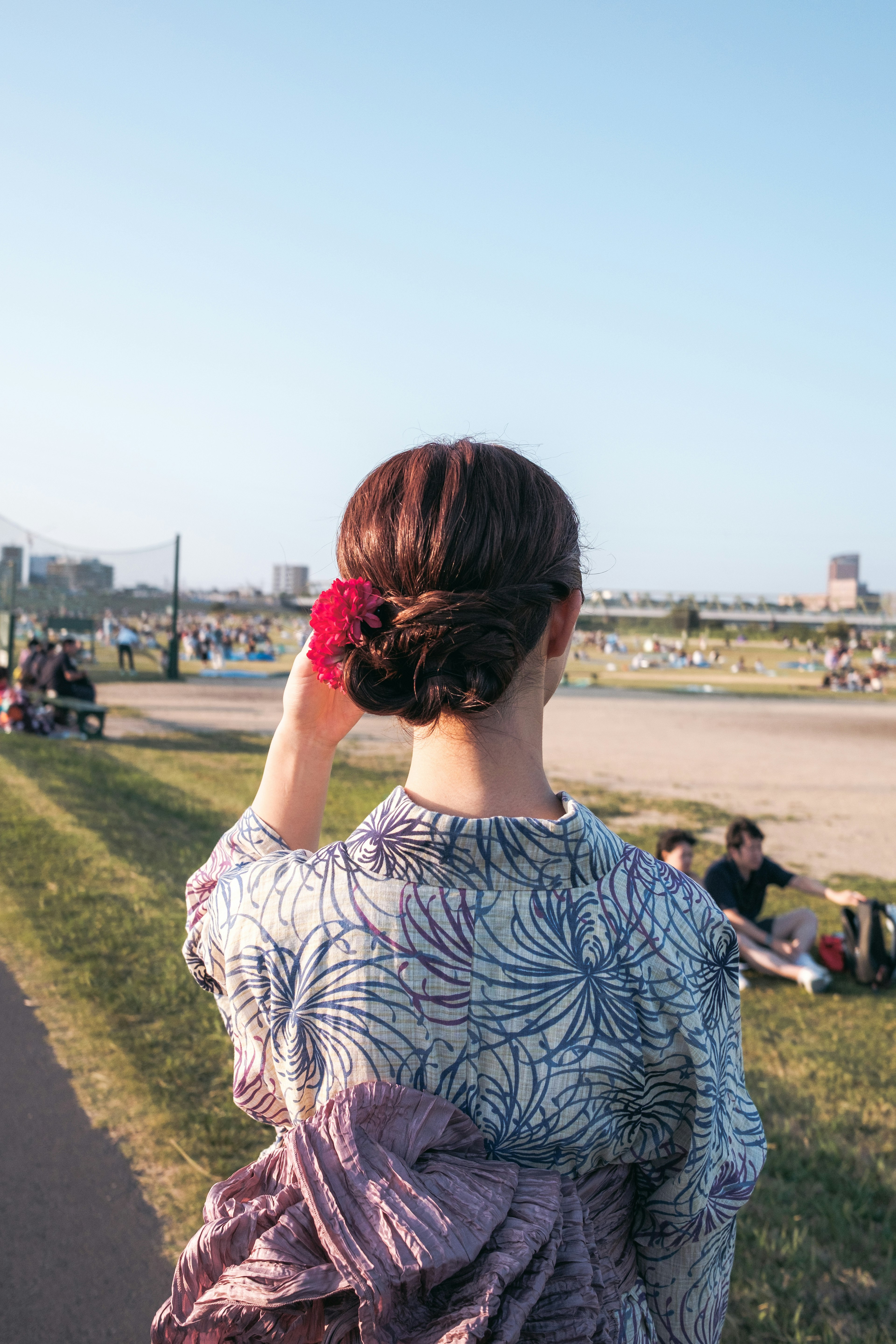 Woman wearing a kimono looking back in a scenic view