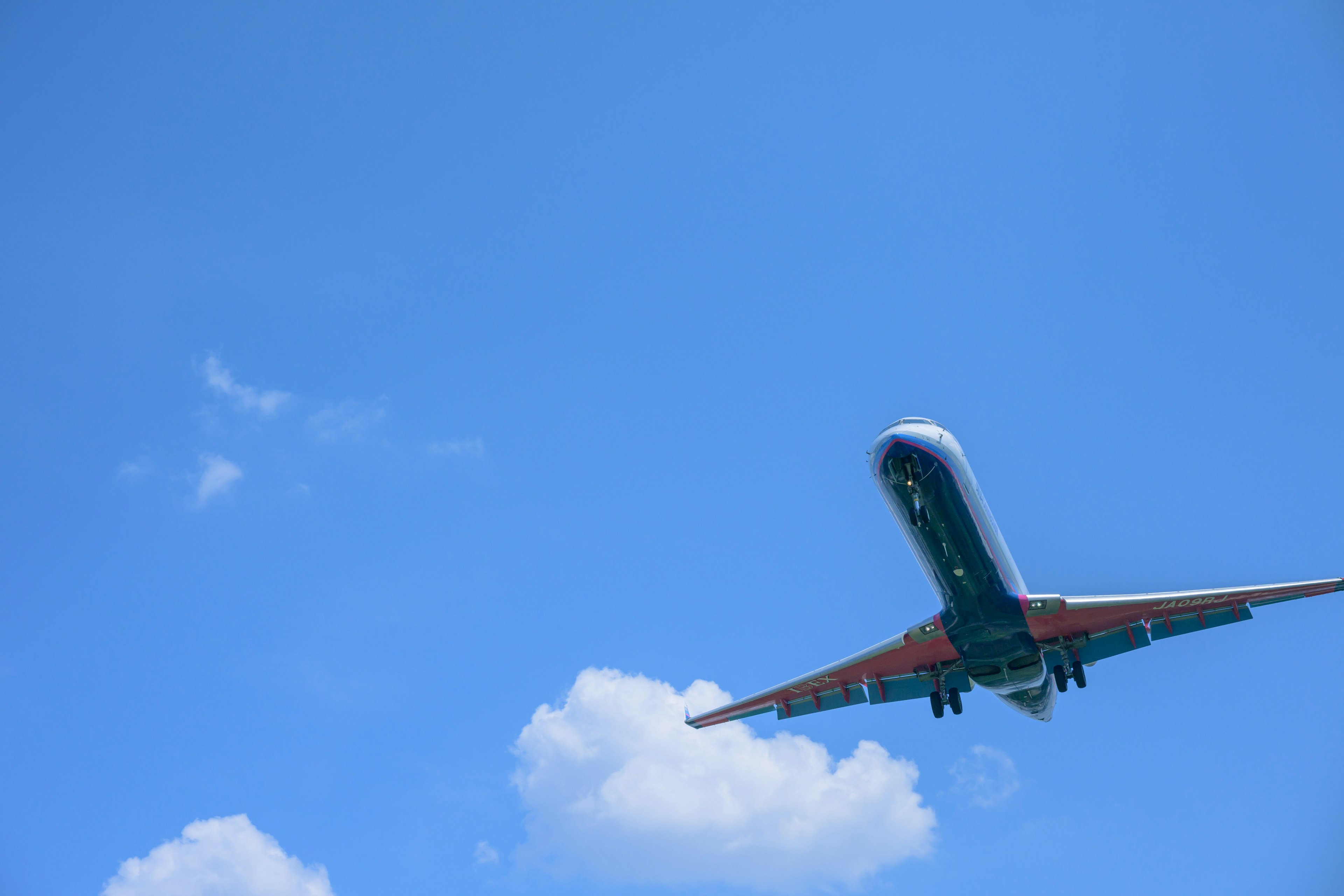 An airplane flying against a blue sky