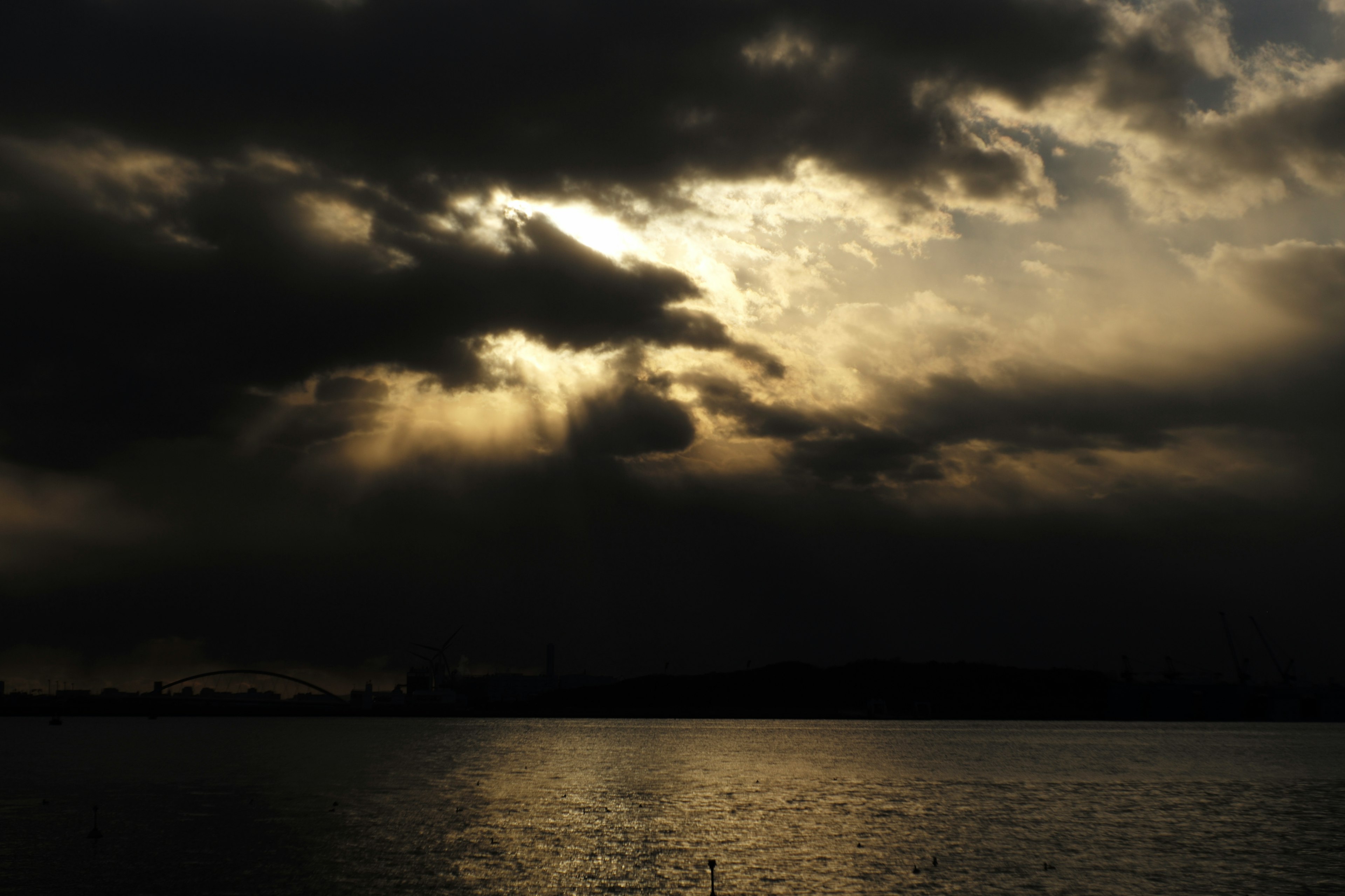 Dramatic sky with dark clouds and rays of light shining through