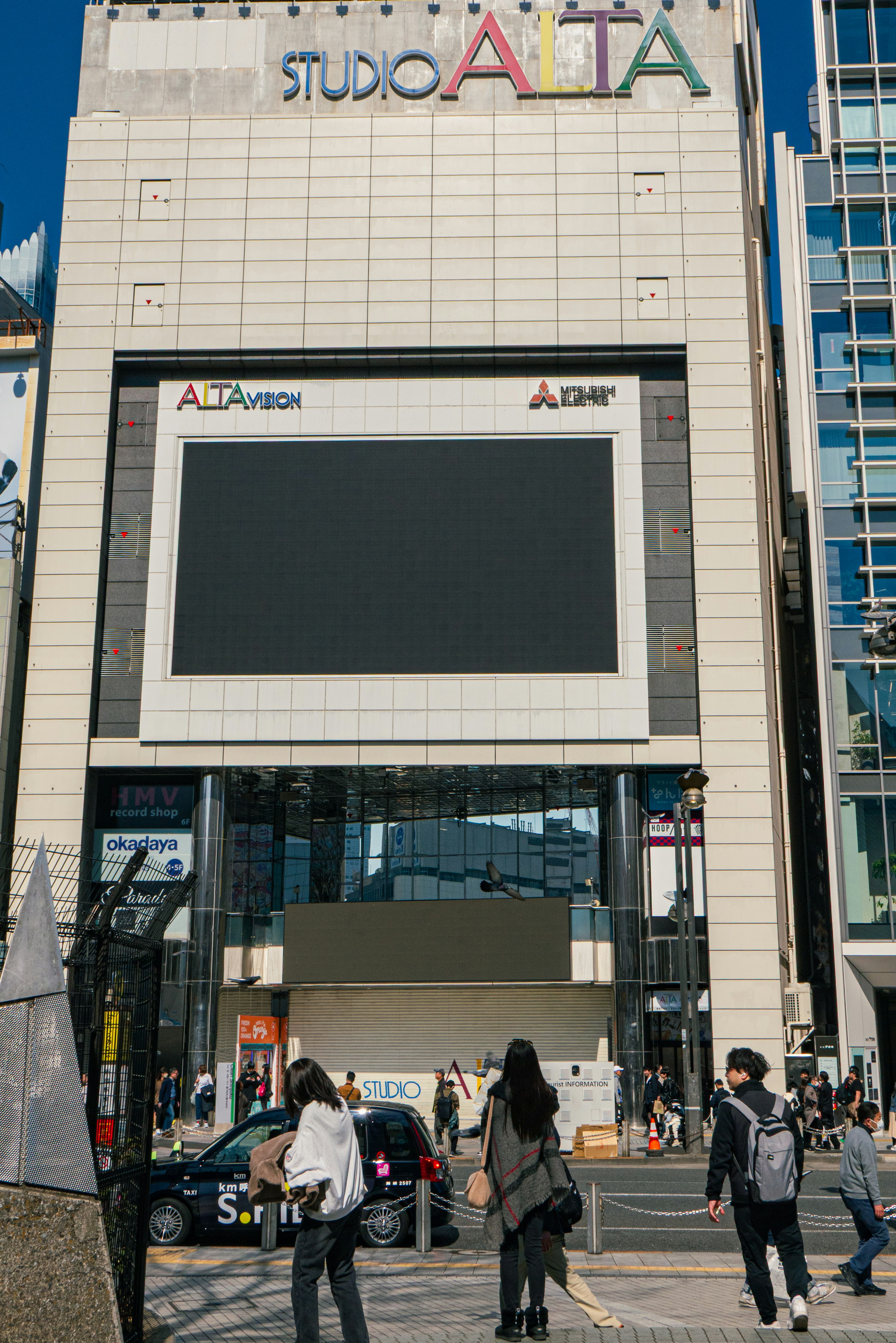 Exterior view of Studio Alta with pedestrians walking