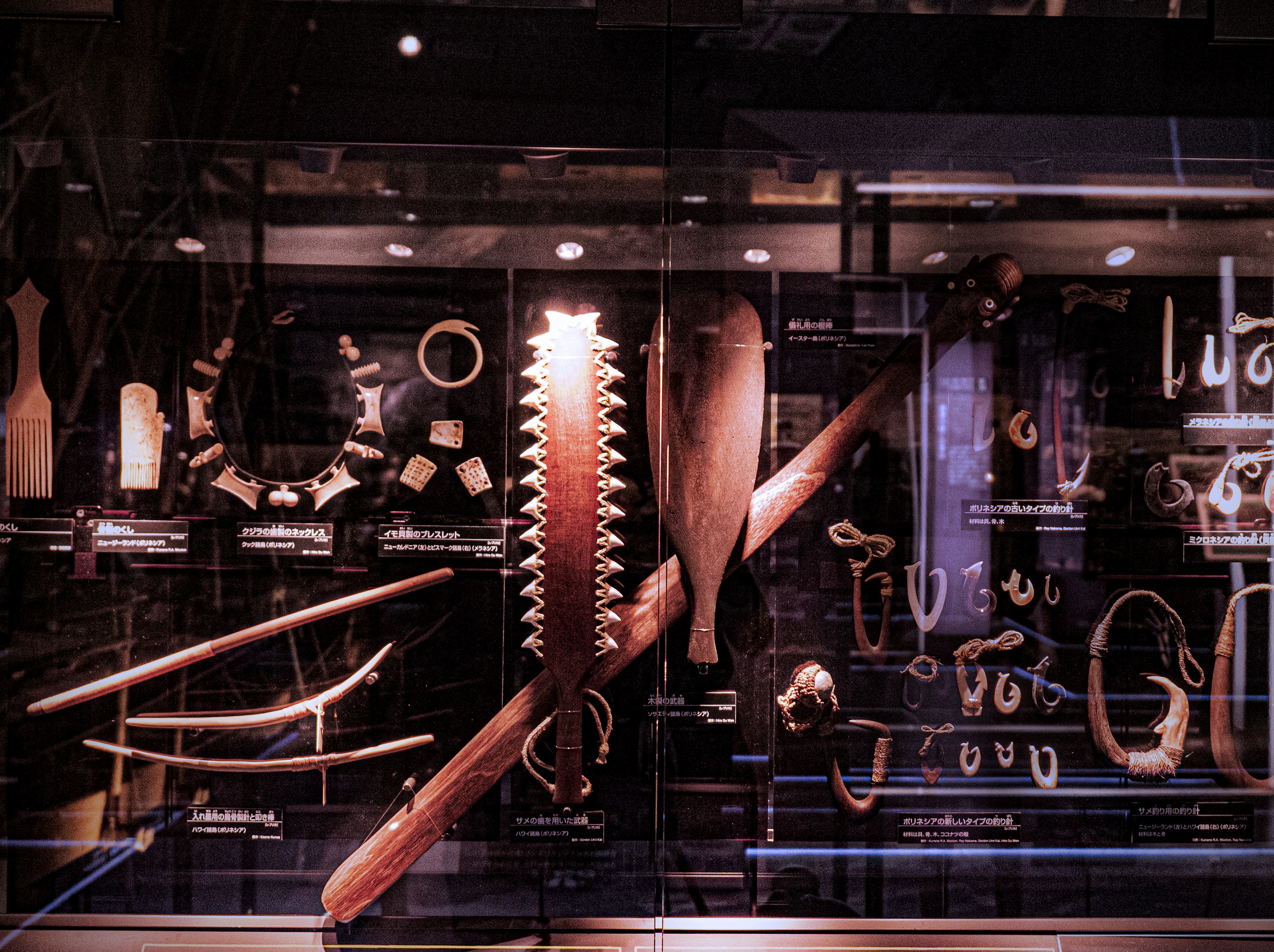 Collection of traditional wooden tools and ornaments displayed in a museum