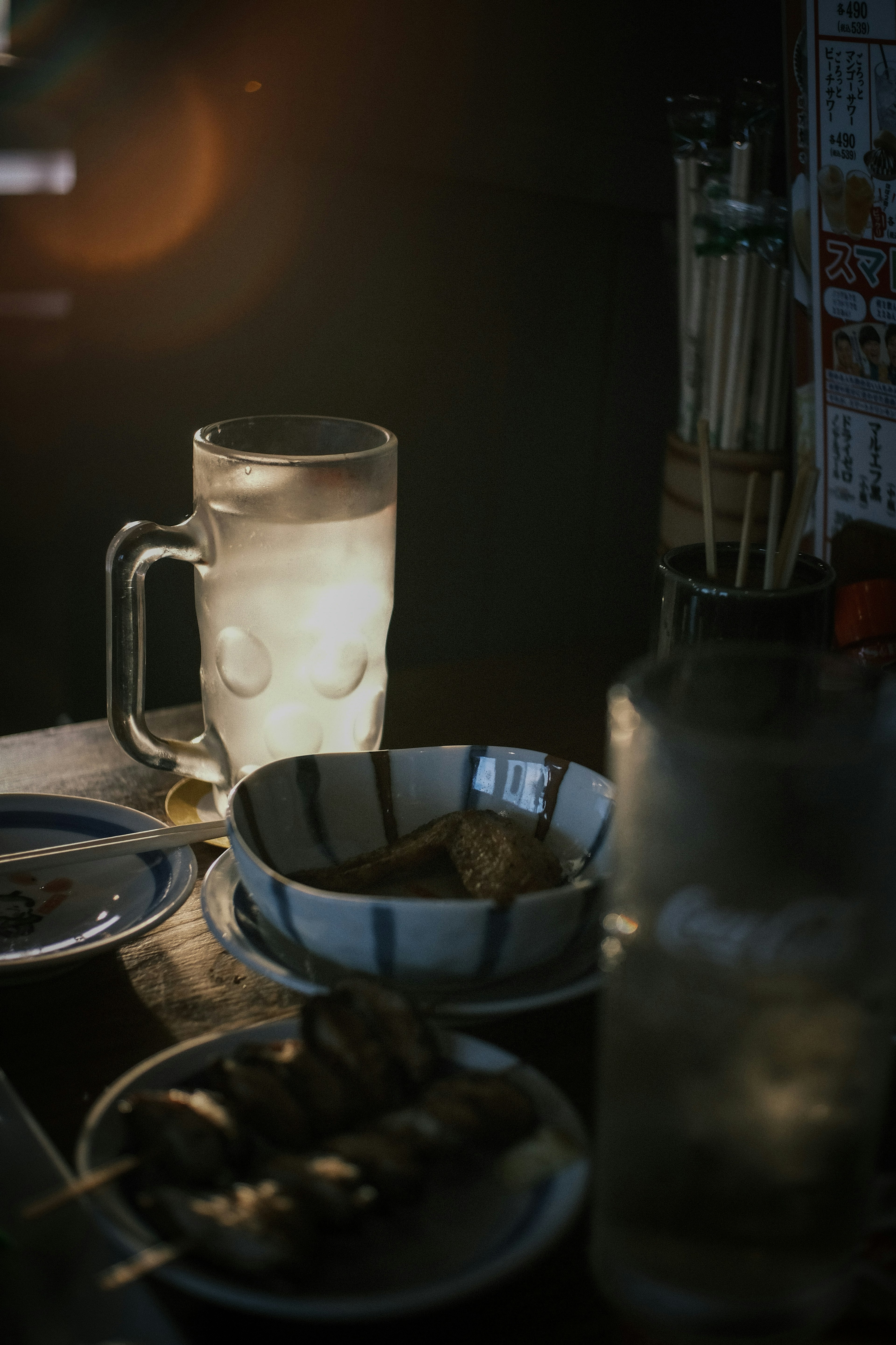 A table setting featuring a cold drink and a bowl of food