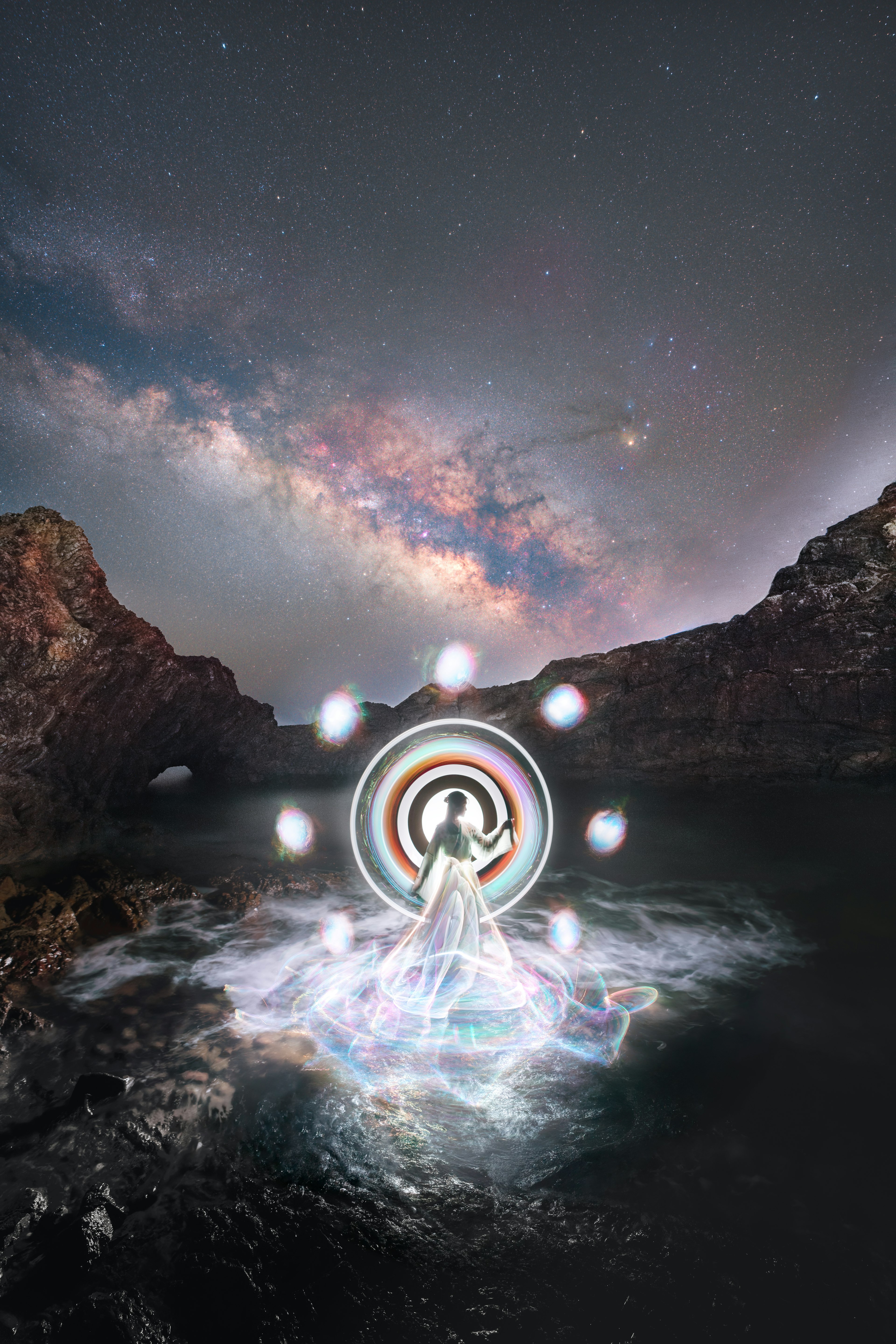 A woman standing in the water surrounded by a luminous ring in a mystical landscape