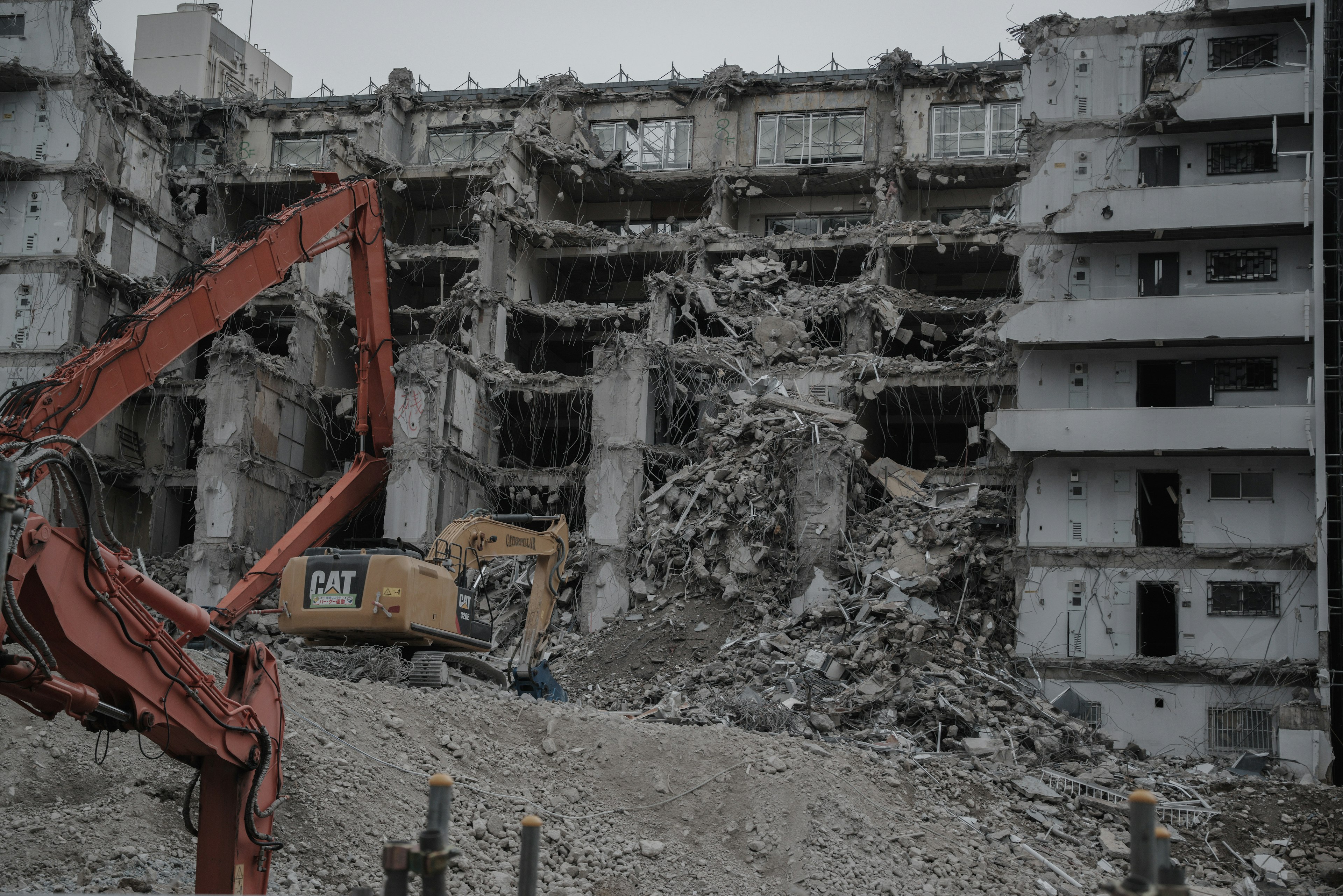 Demolition site with heavy machinery working on a building