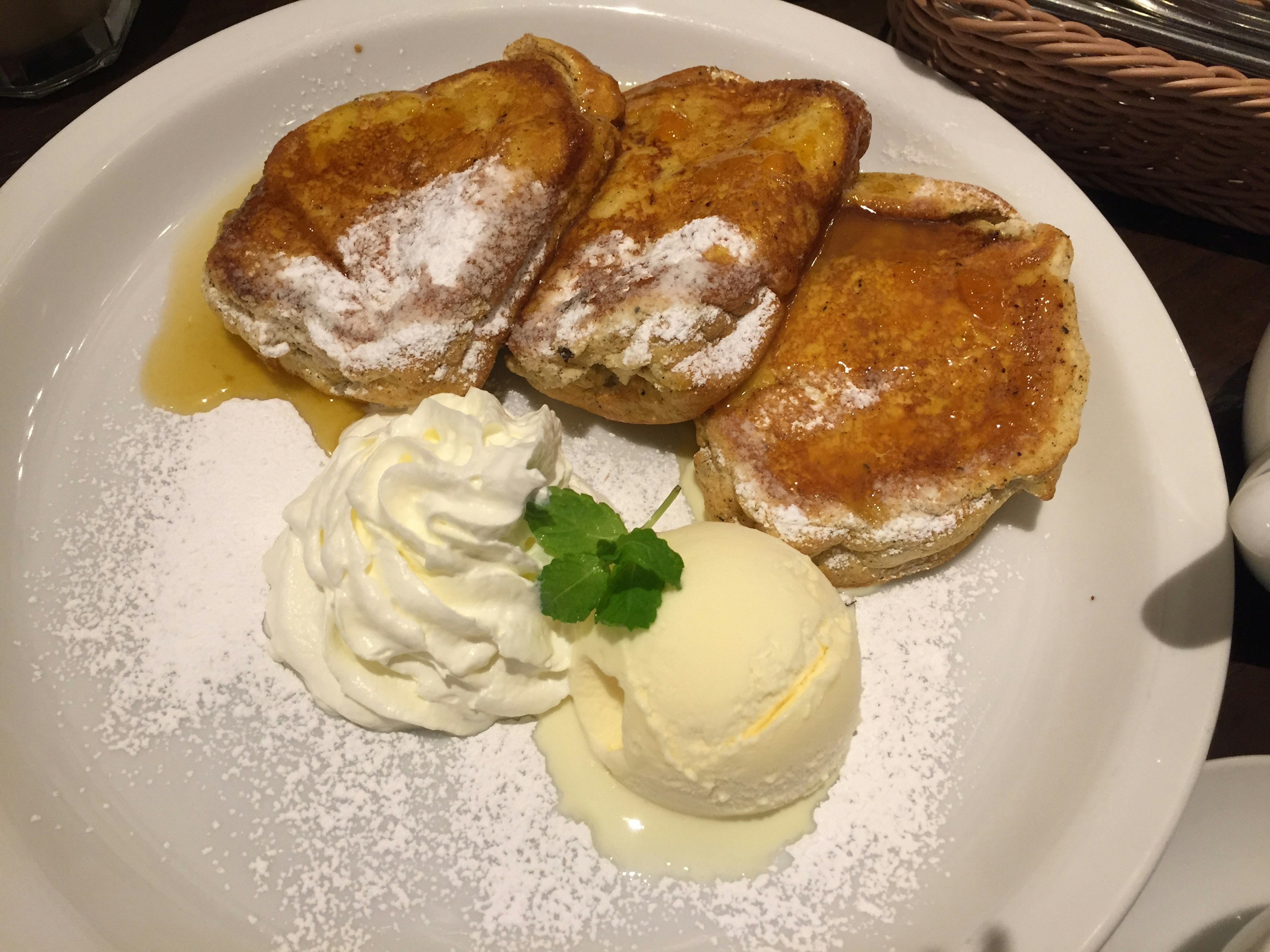 French toast served with powdered sugar, ice cream, and whipped cream