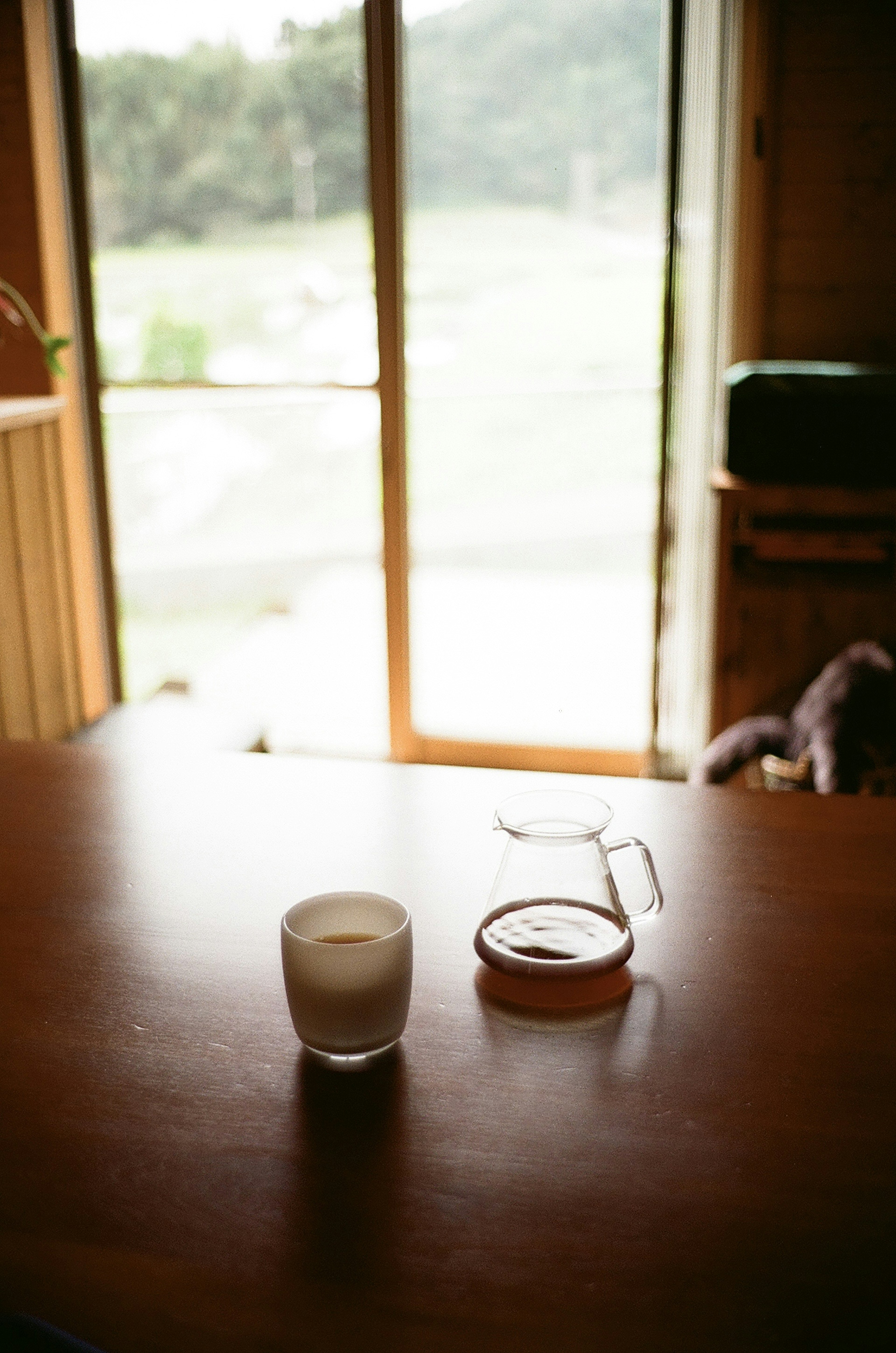 A serene indoor scene with a candle and a small dish on a wooden table