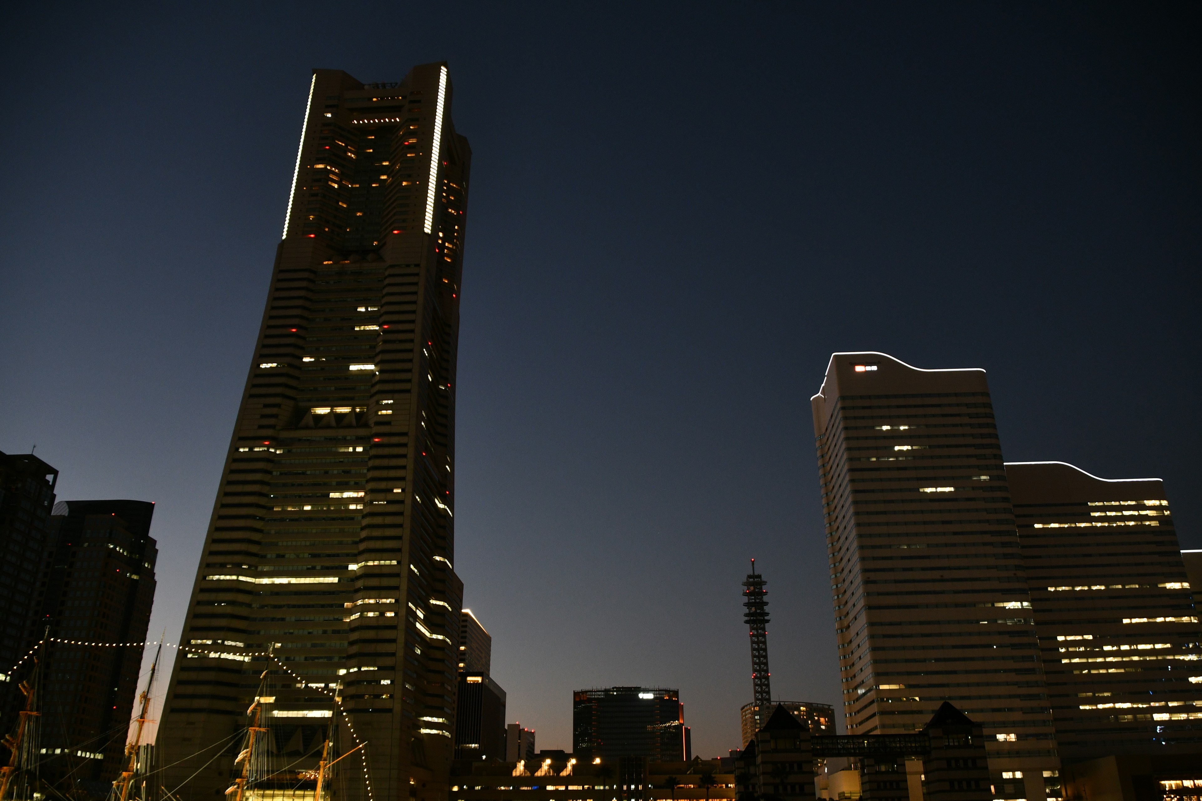 Night cityscape with skyscraper silhouettes illuminated buildings