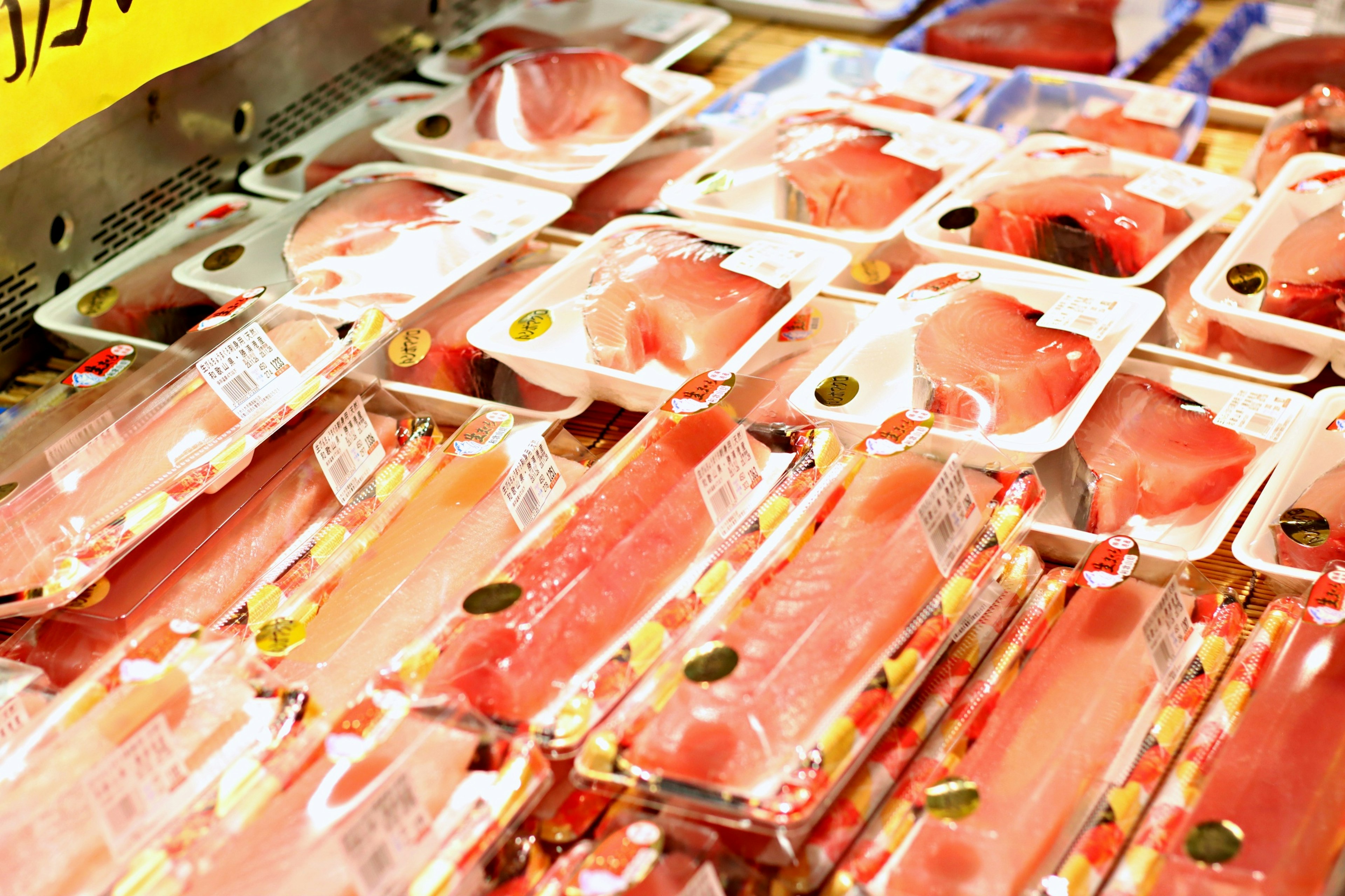 Bright red fish fillets packaged neatly on display