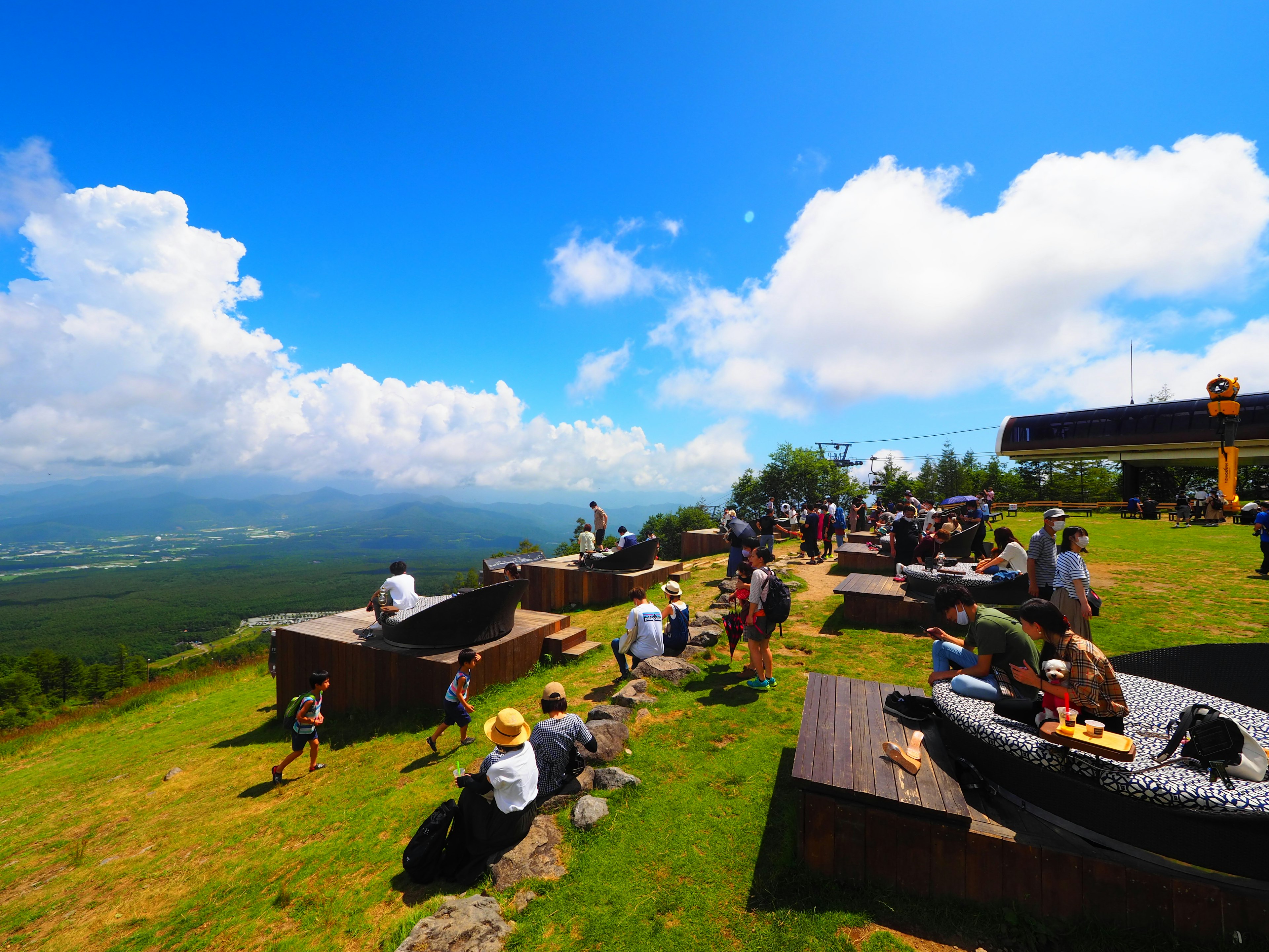 Des gens profitant d'une journée ensoleillée sur de l'herbe verte avec une vue panoramique