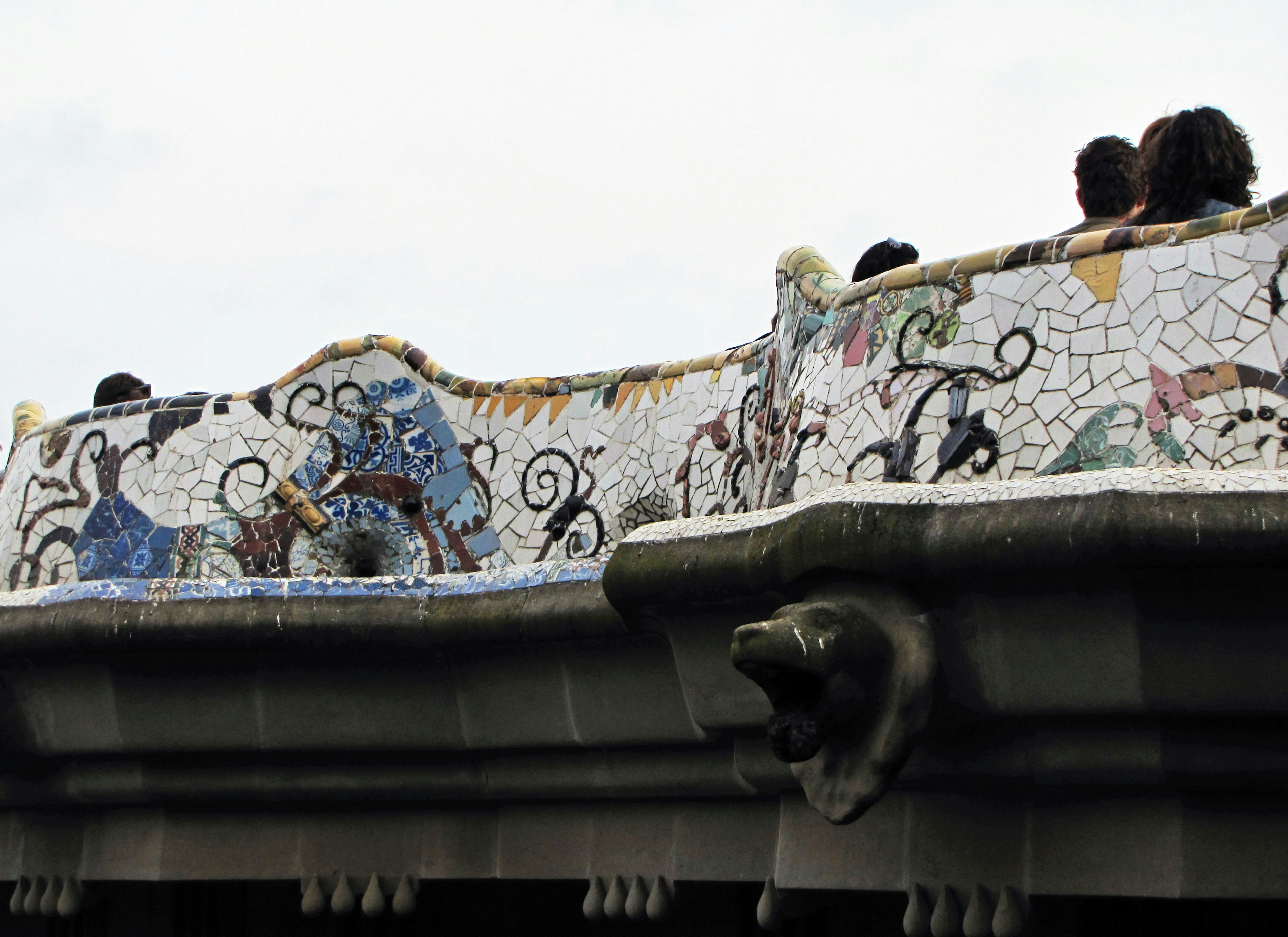 Mosaic decorated balcony at Park Güell in Barcelona with visitors