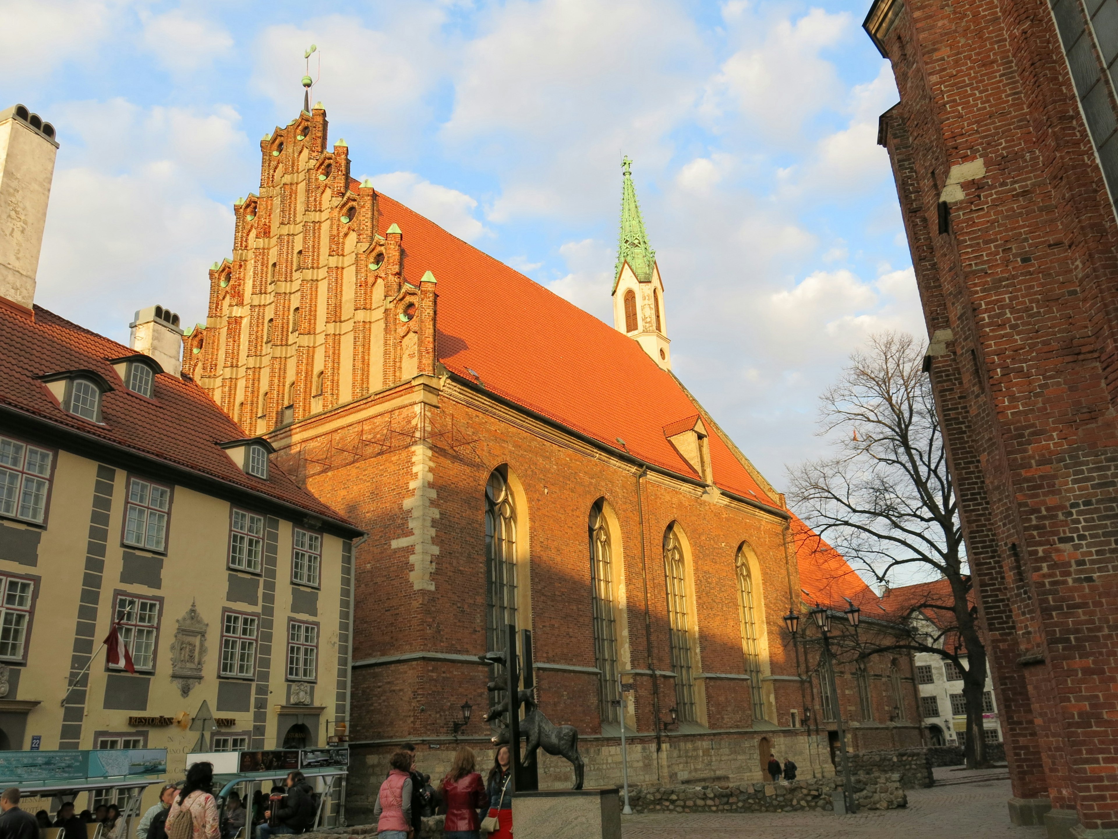 Gothic church with a red roof illuminated by sunset