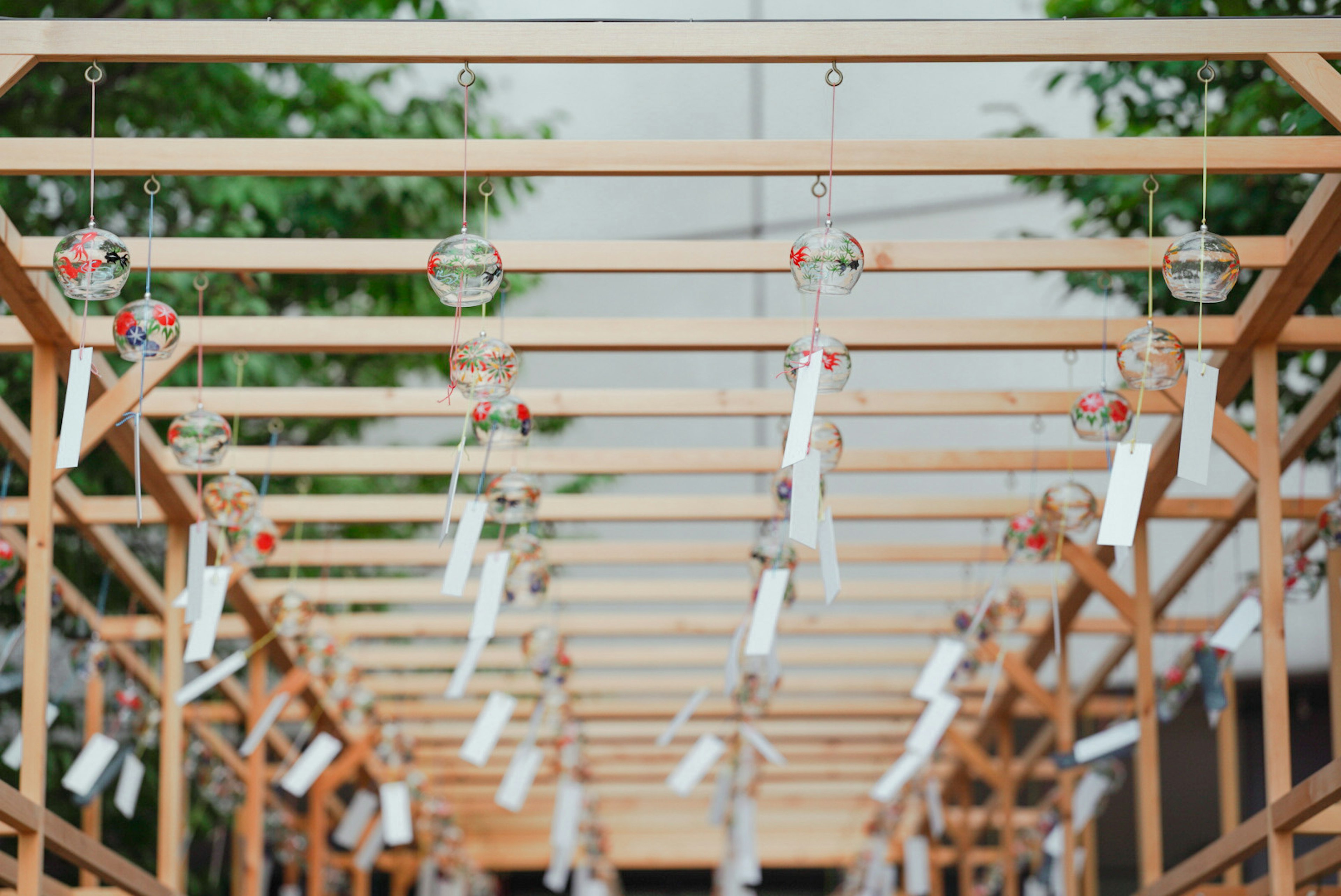 Wooden frame with hanging wind chimes and tanzaku