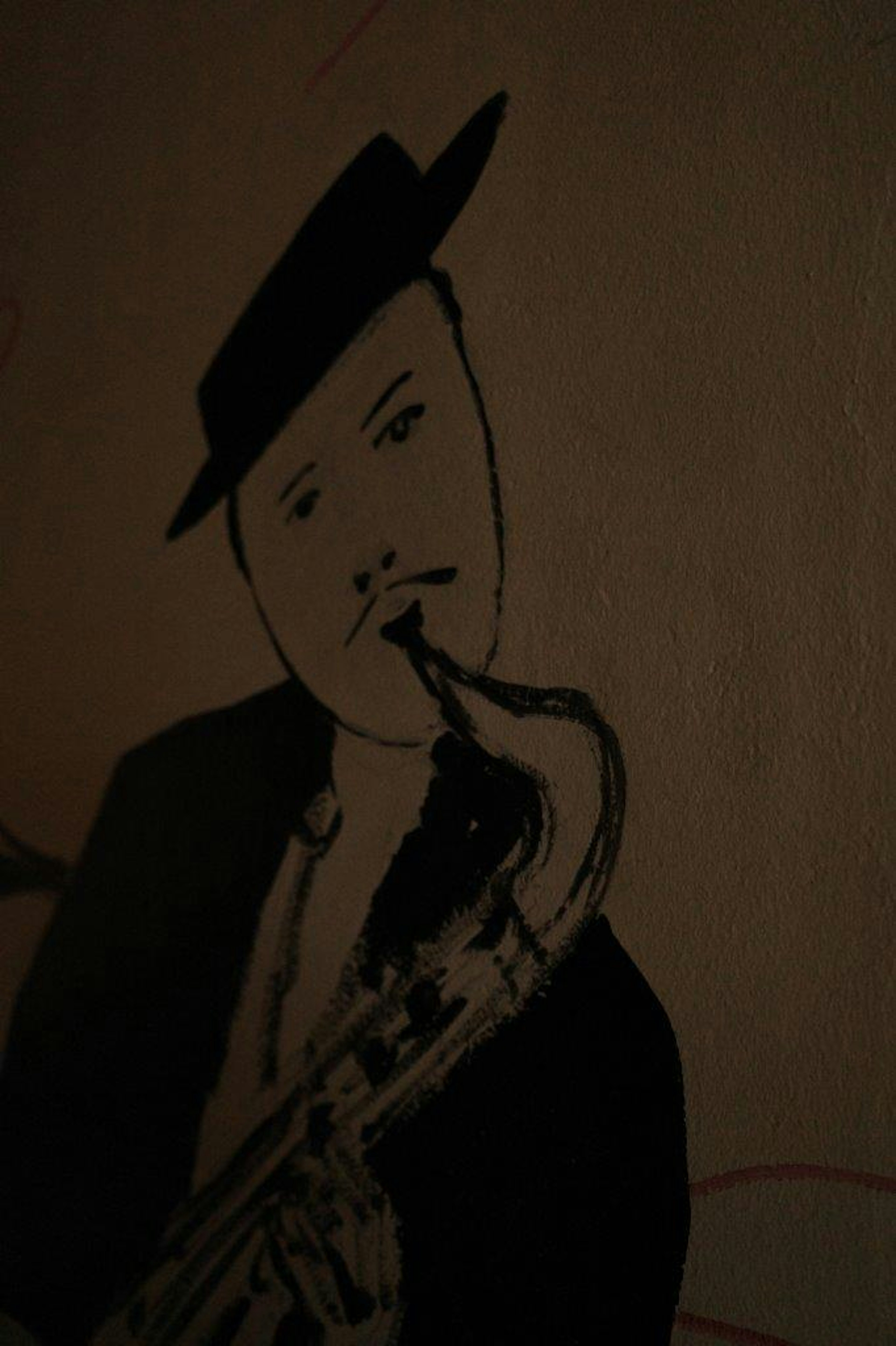 Silhouette artwork of a man playing the saxophone