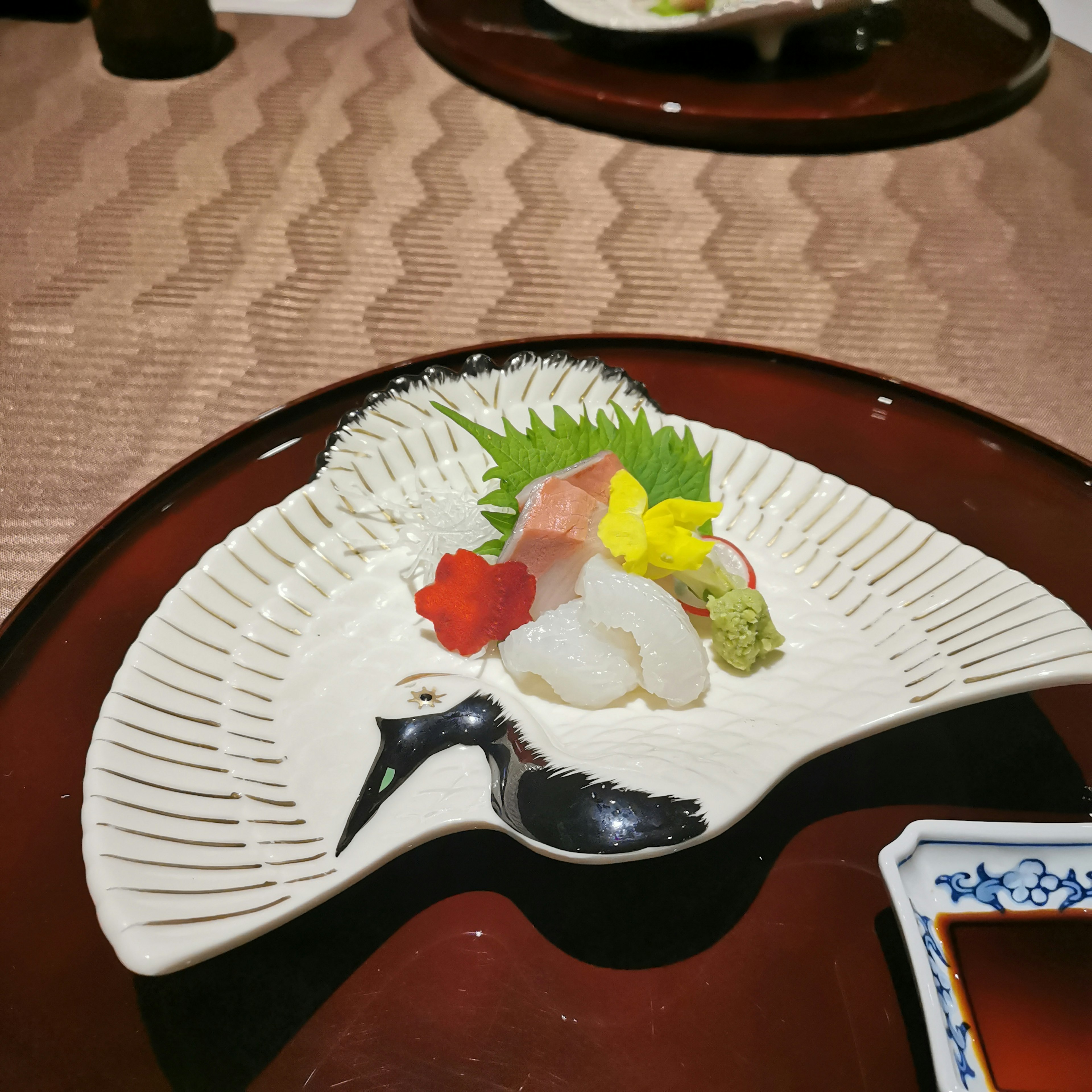 Beautiful Japanese plate featuring fresh sashimi and colorful garnishes