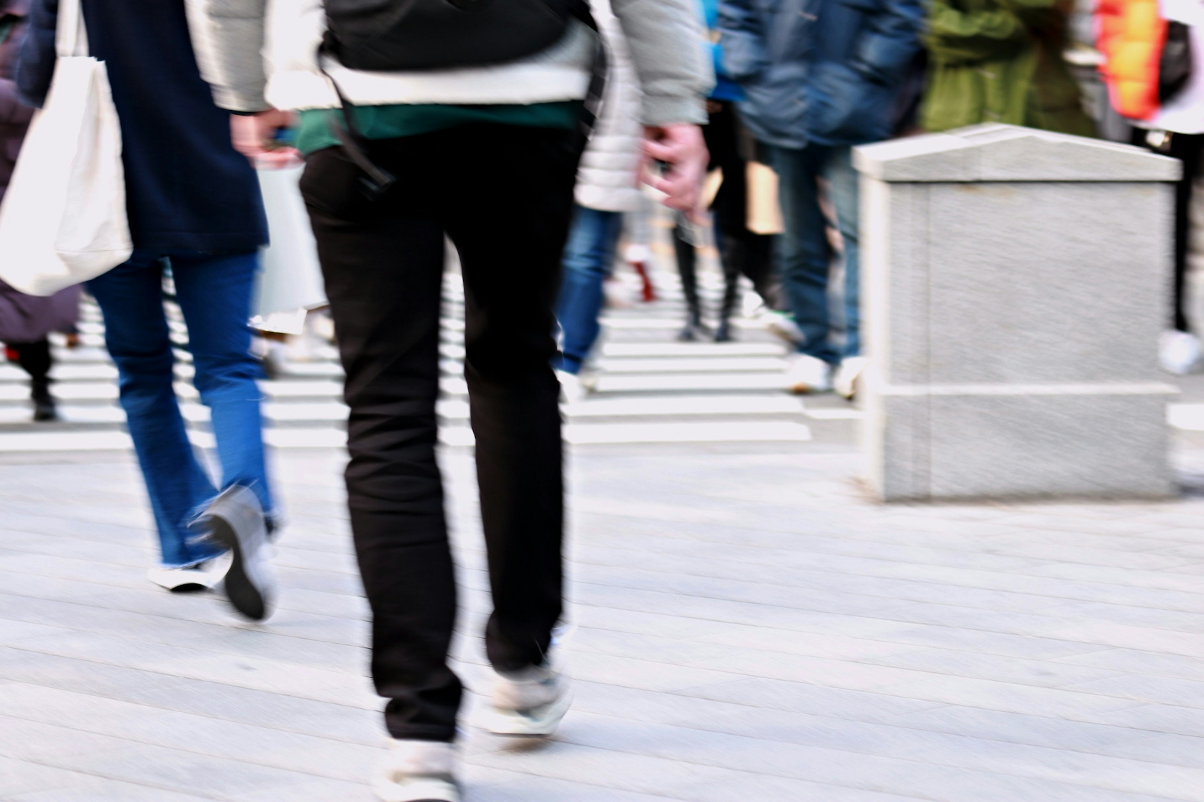 Image capturing people crossing the street person walking from behind