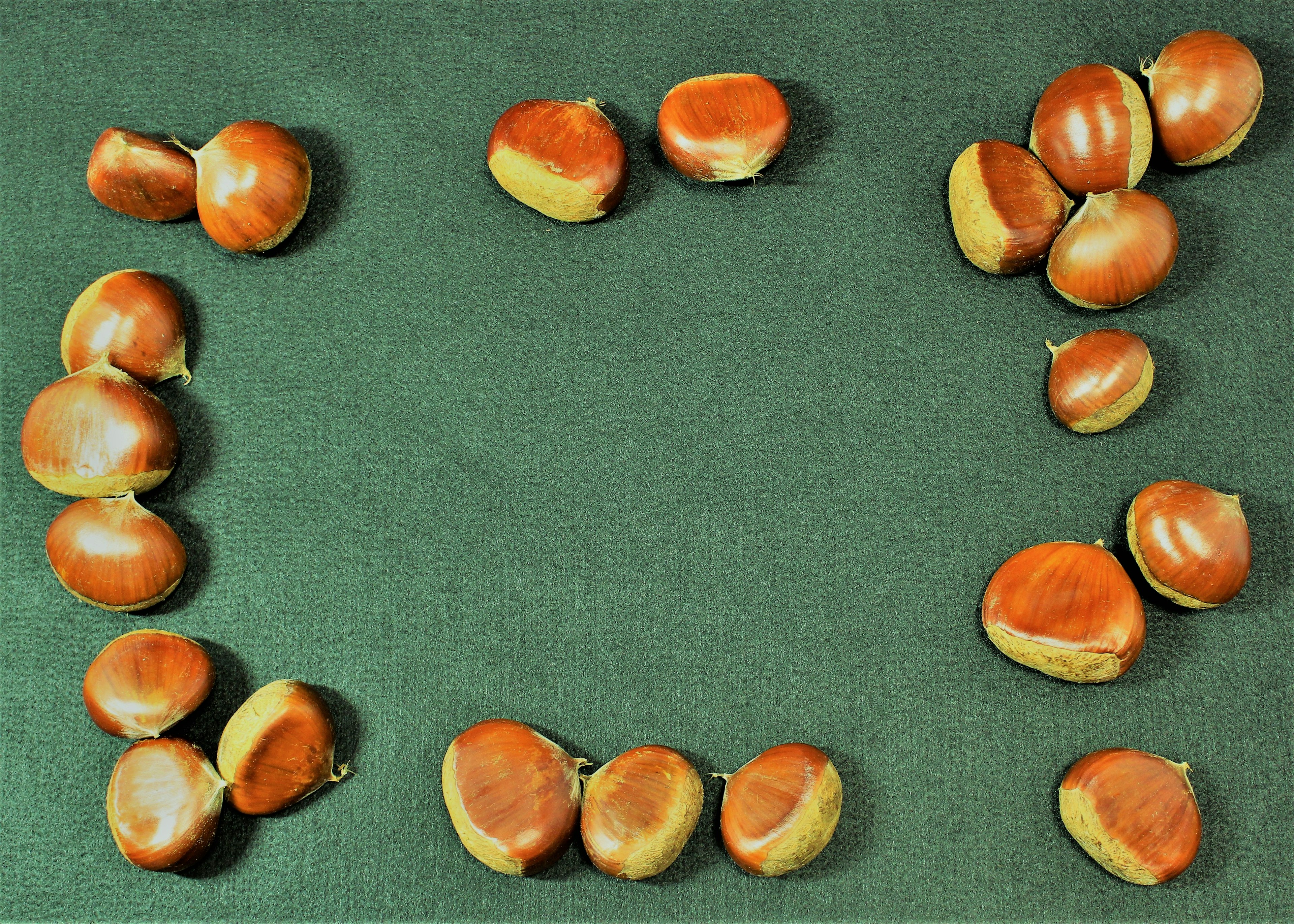 Castagne disposte su un tessuto verde