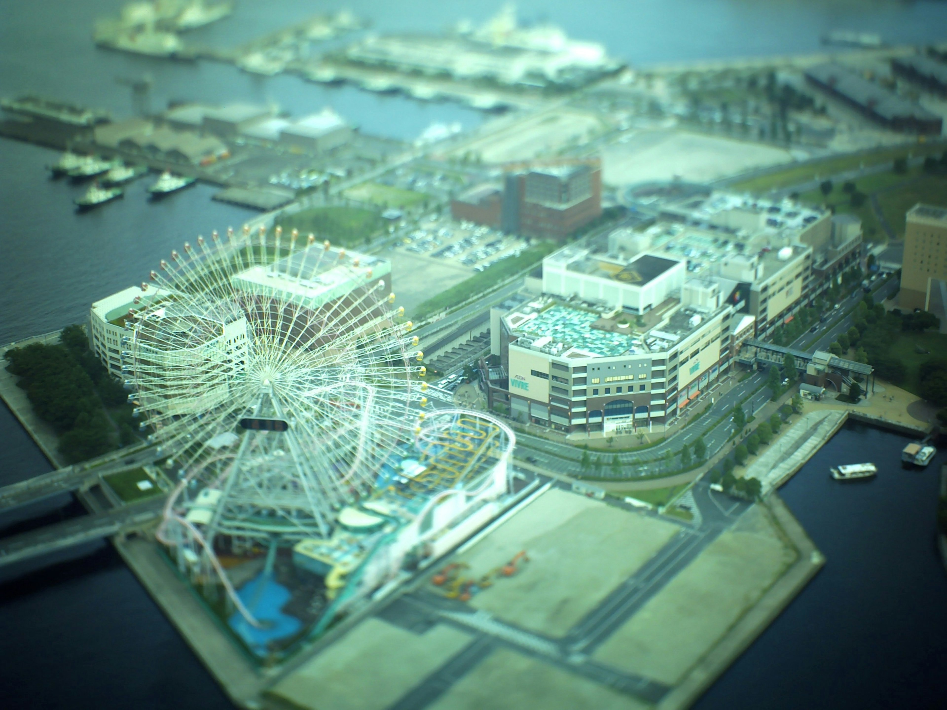 Aerial view of a city with a ferris wheel and waterfront