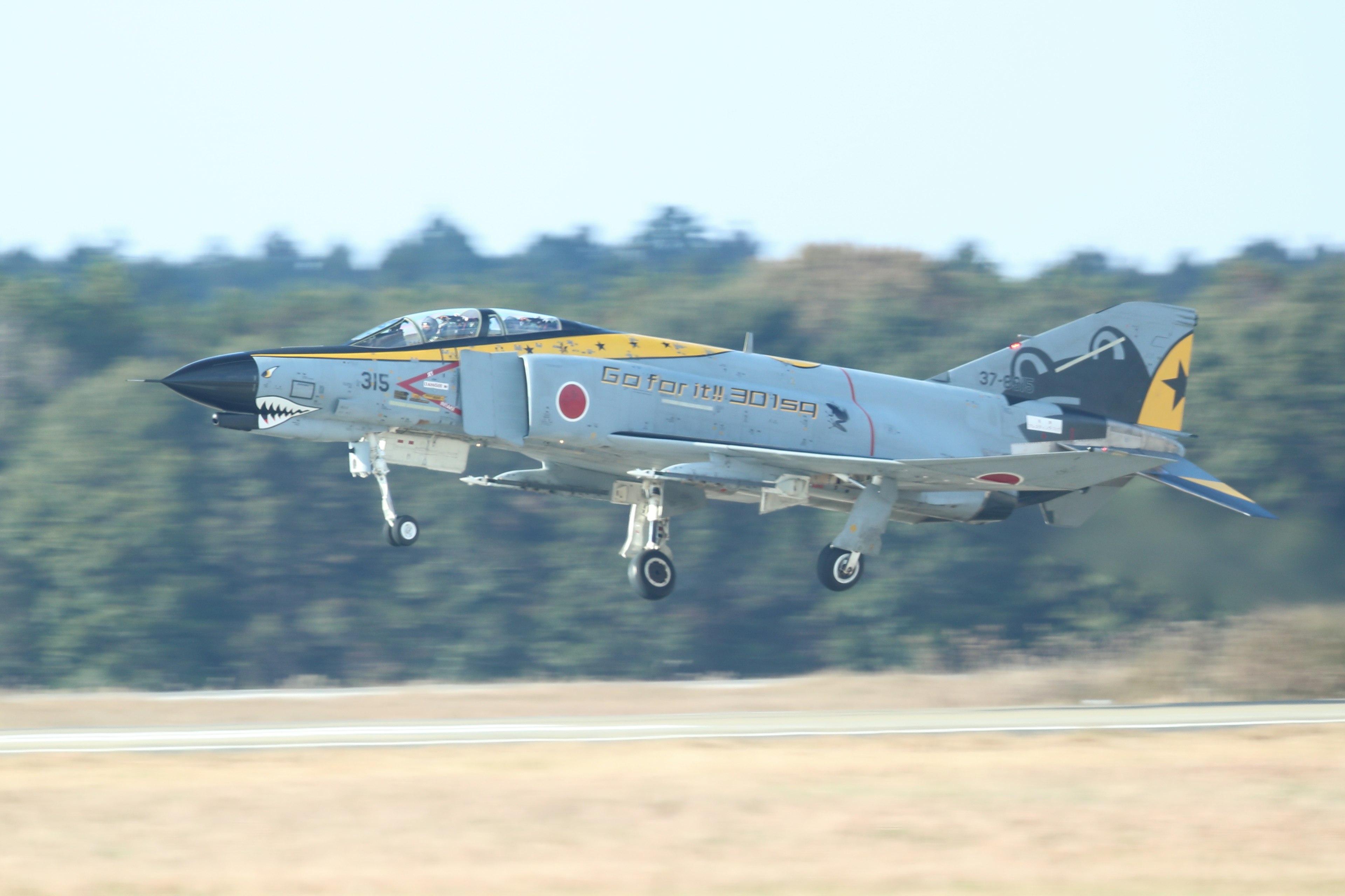 Japanisches F-4 Phantom Flugzeug, das mit klarem Himmel im Hintergrund startet