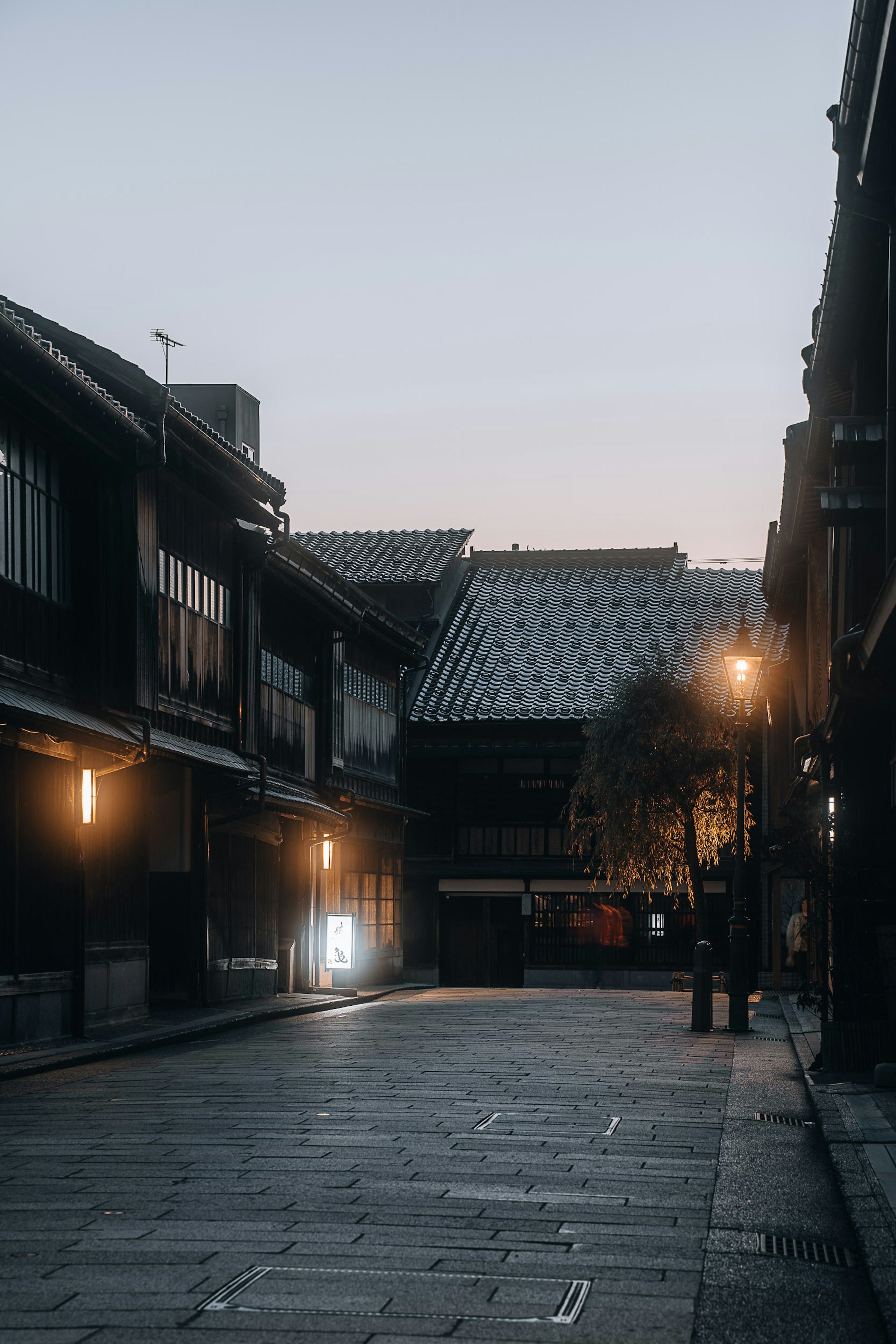 Quiet street at dusk with traditional buildings and soft lighting