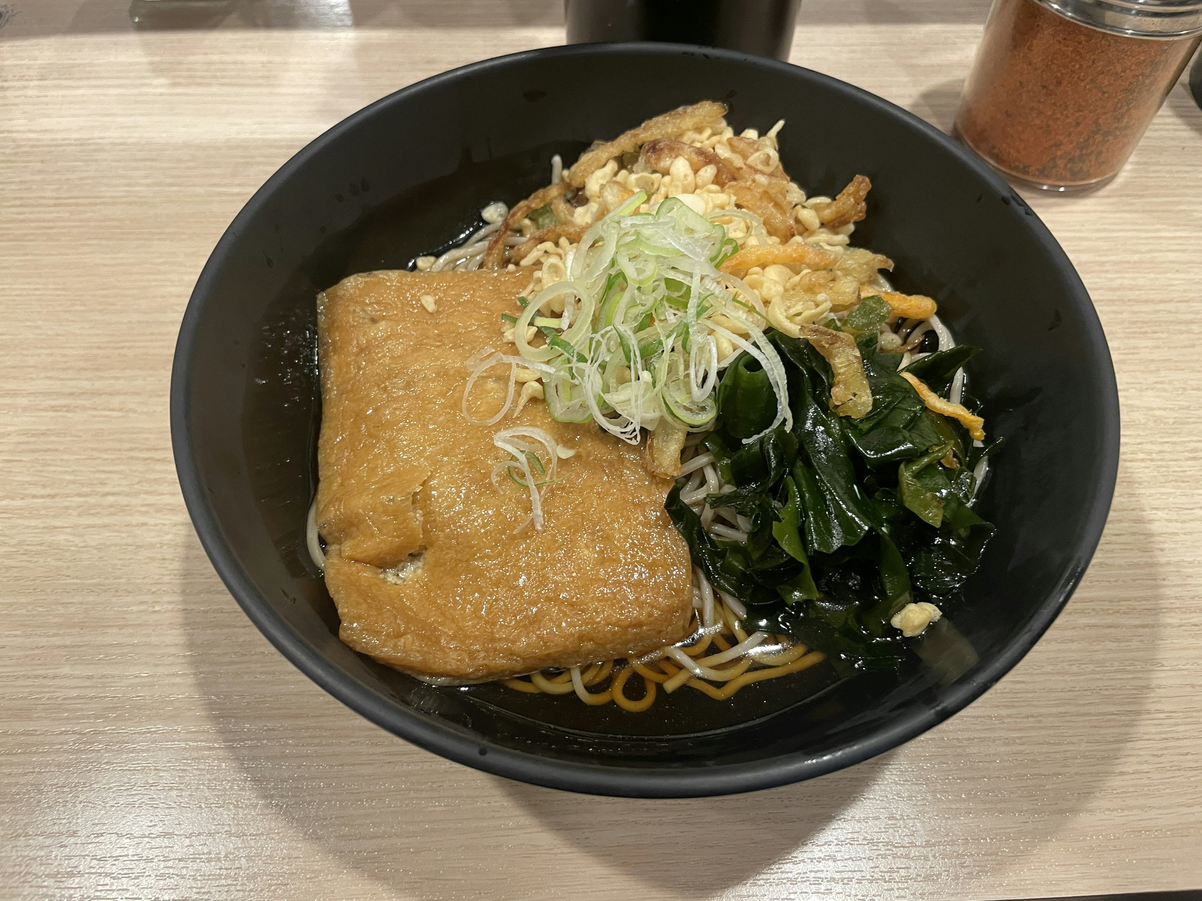 Bowl of ramen topped with seaweed and shredded cabbage