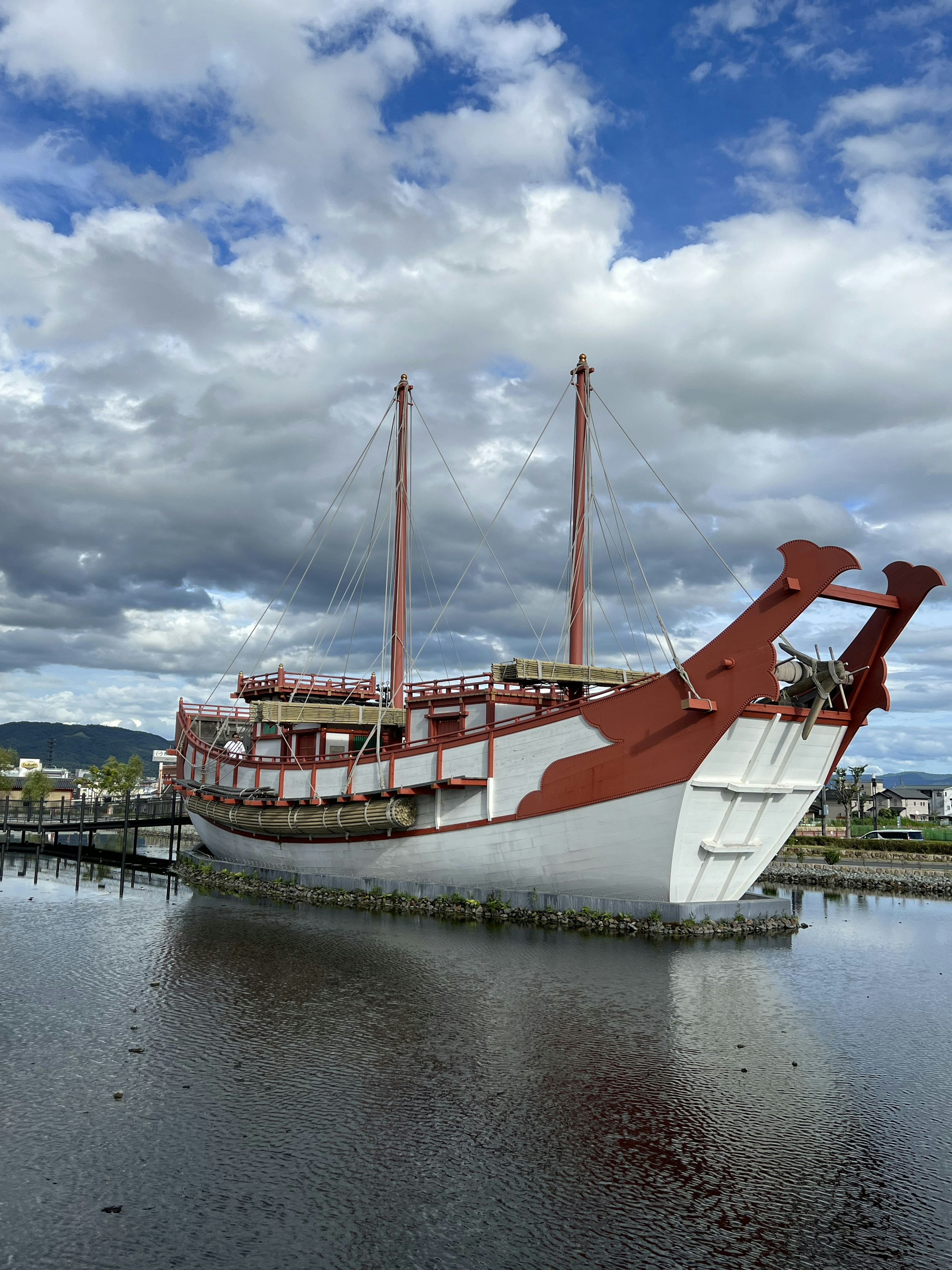 A beautiful scene of a red and white ship floating on the water