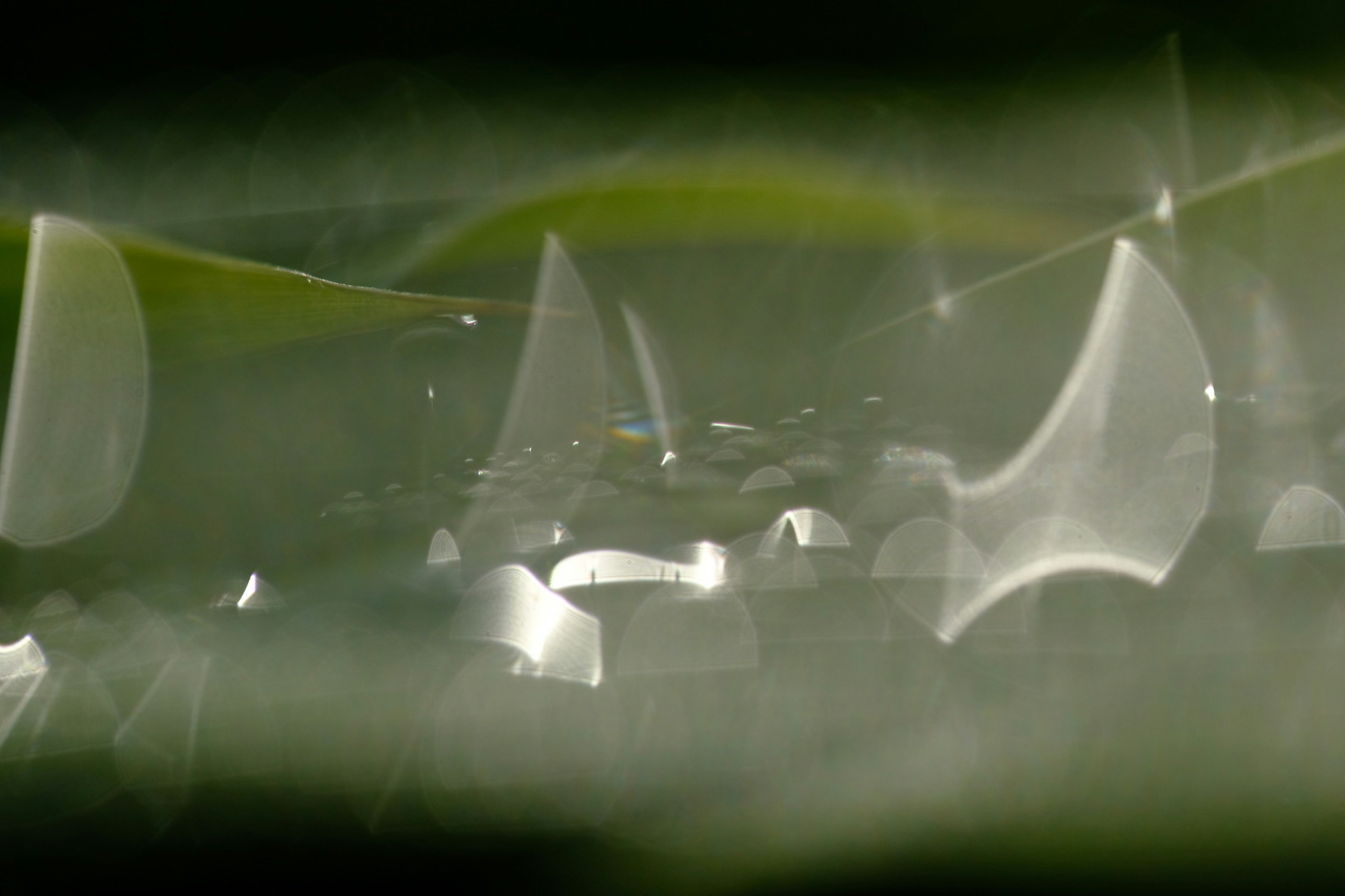 Image of a blurred metallic surface against a green background