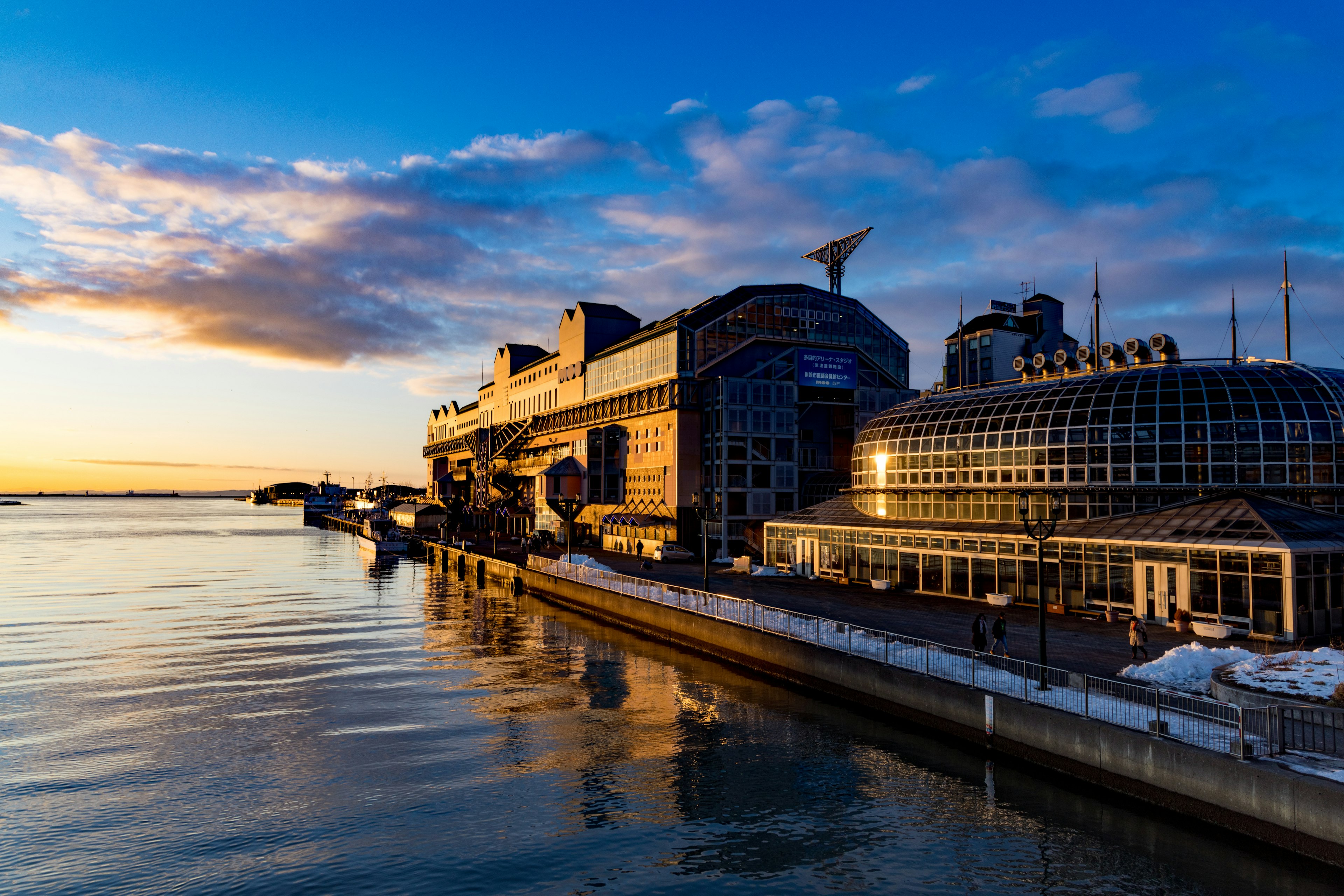 Building by the waterfront during sunset with calm waters