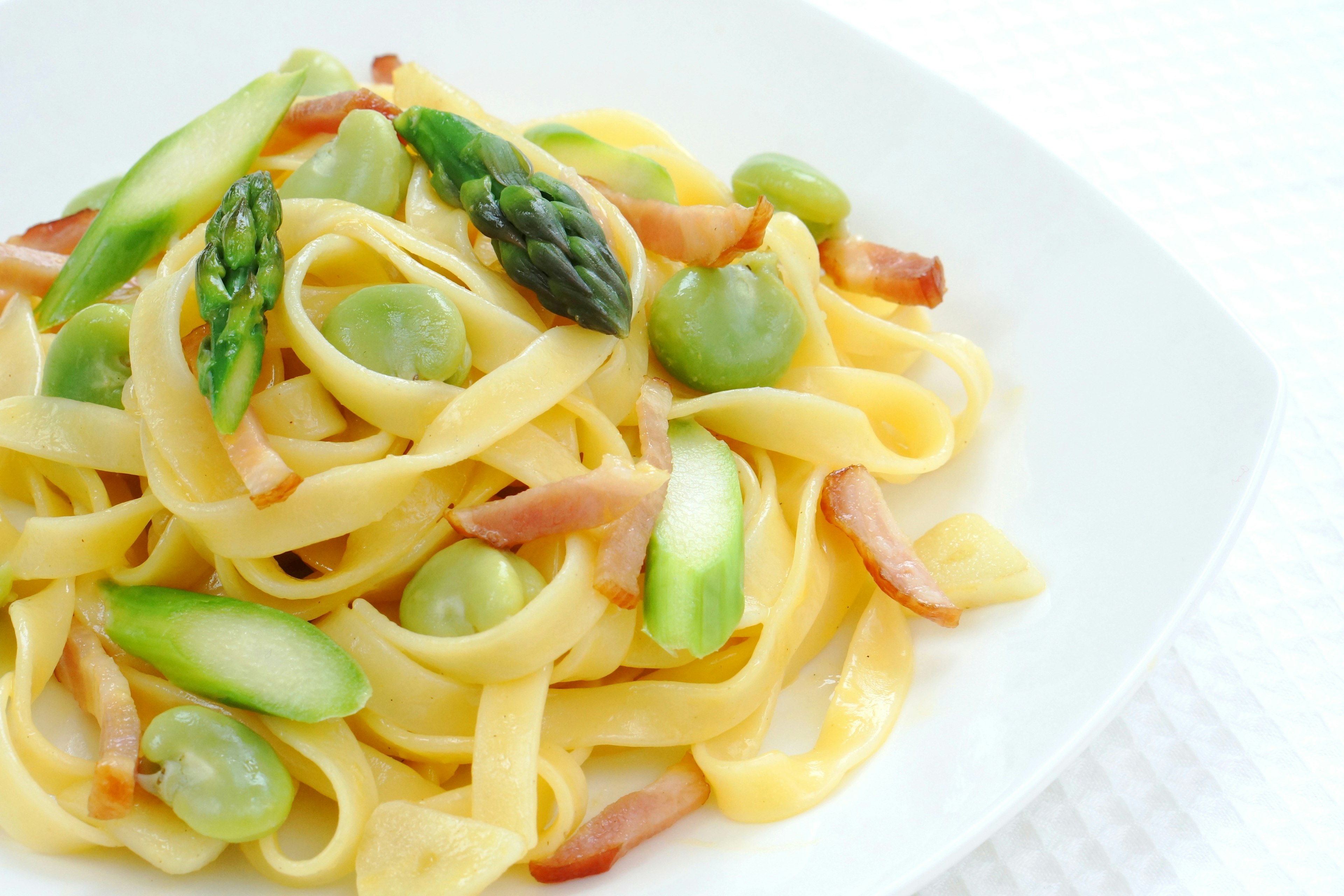 Creamy pasta topped with asparagus and green grapes