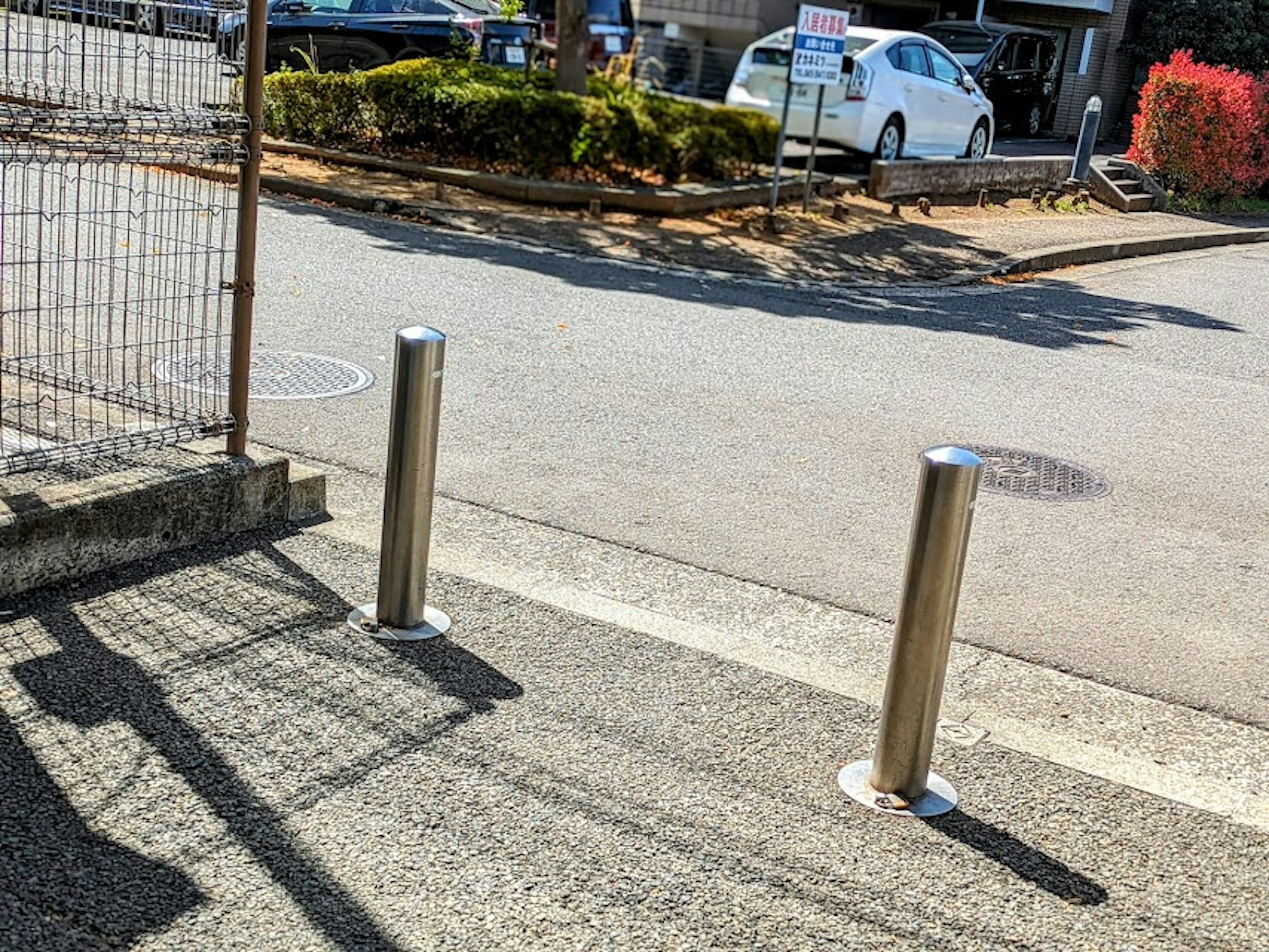 Scene of a sidewalk with metal bollards installed